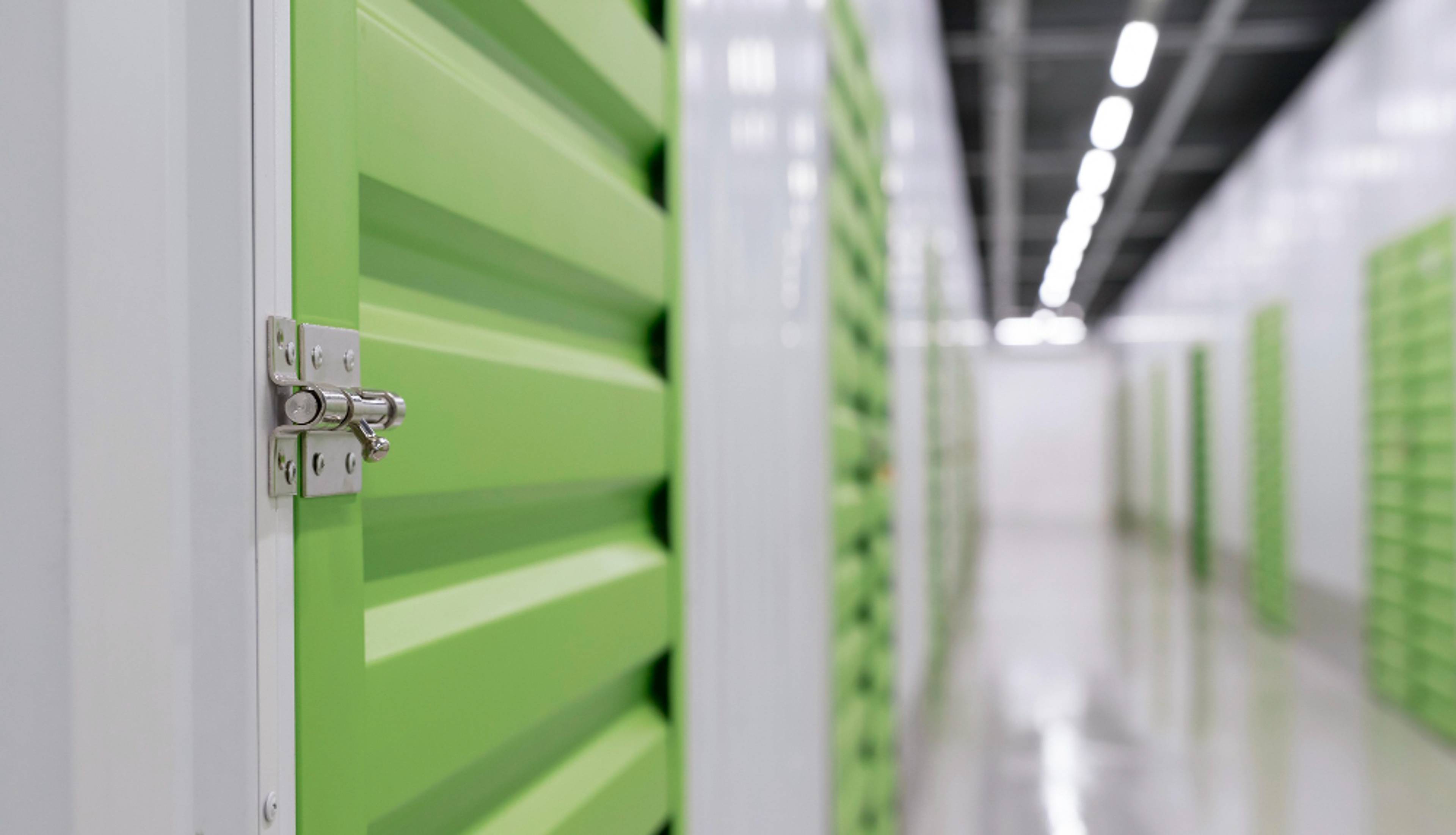 Close up of a green locked storage door