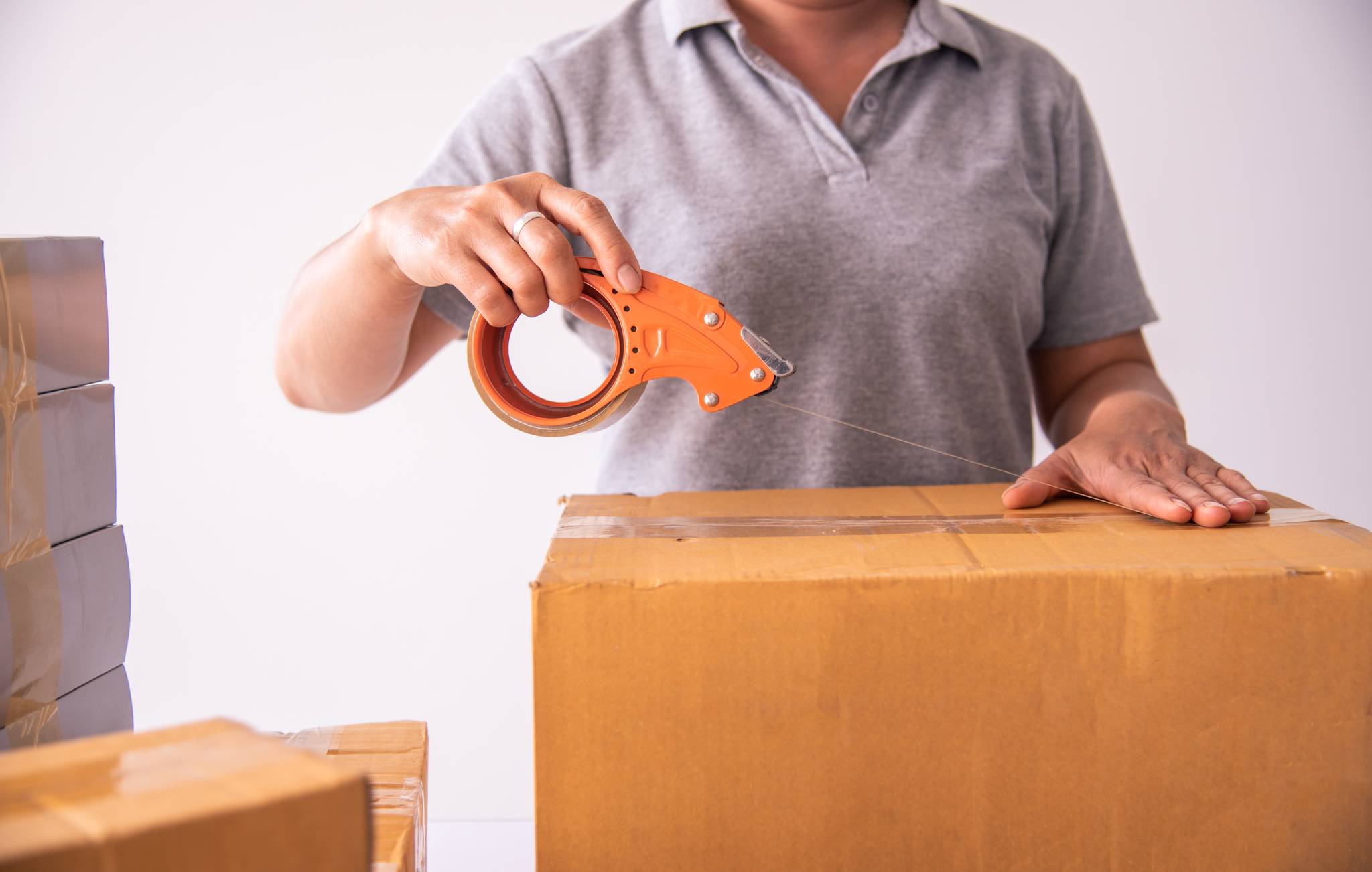 Woman taping a box for storage