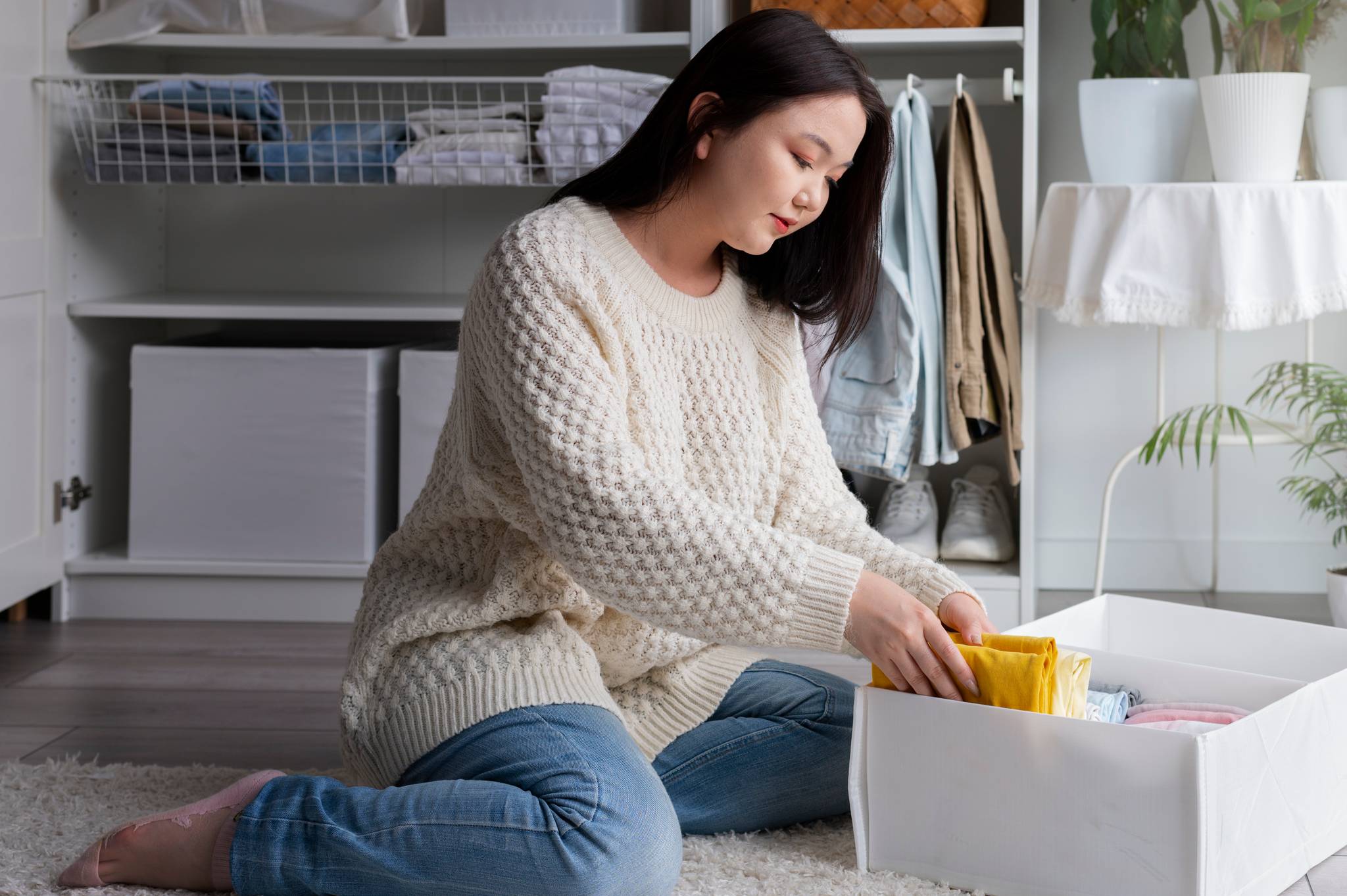 Woman putting away winter clothes
