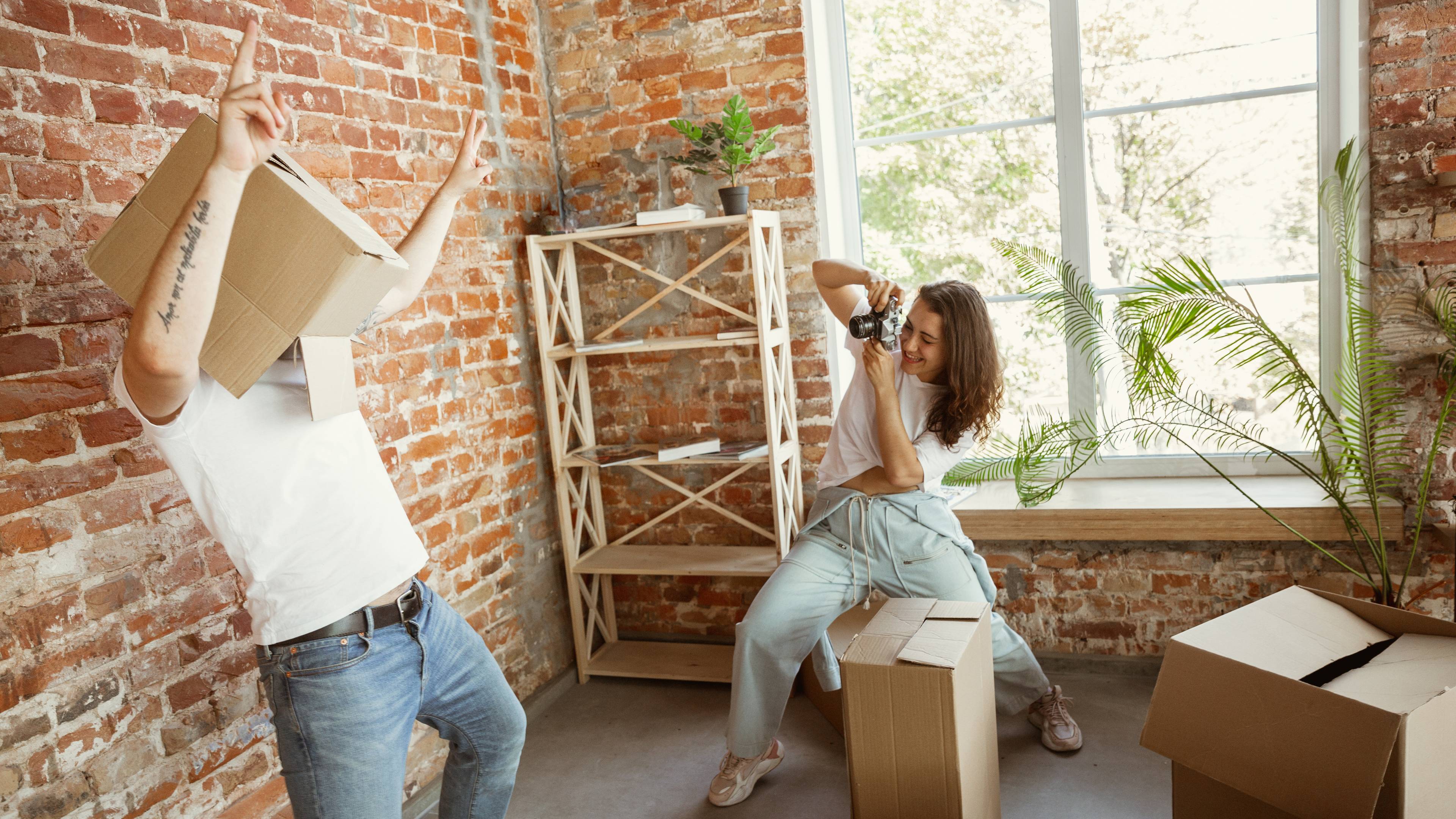 Young couple having fun while working on home