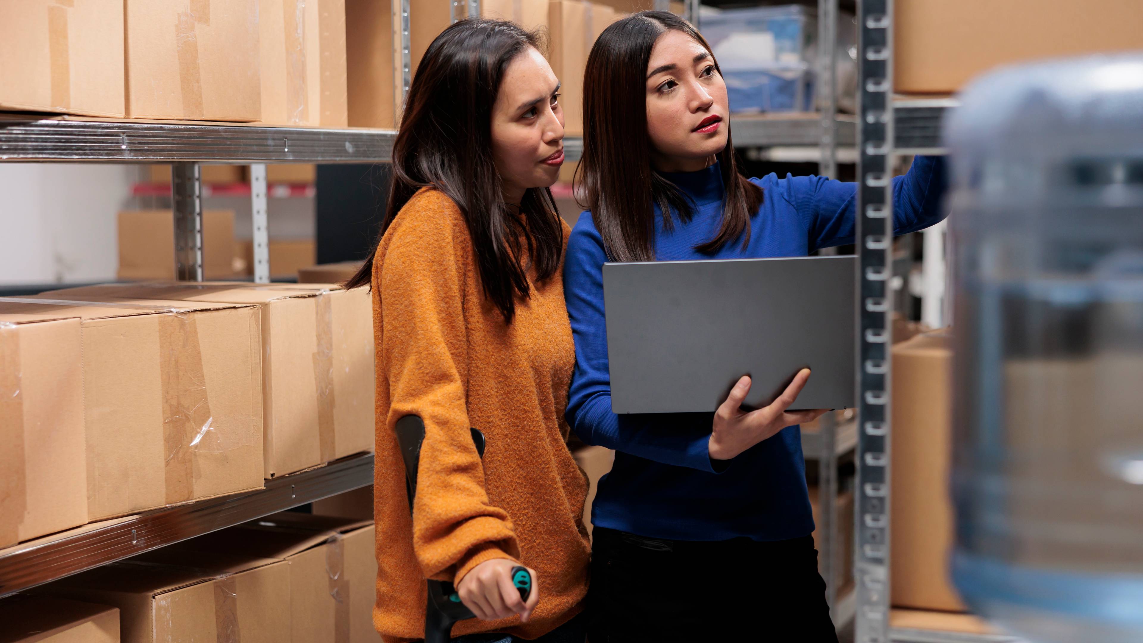 2 women in warehouse with storage