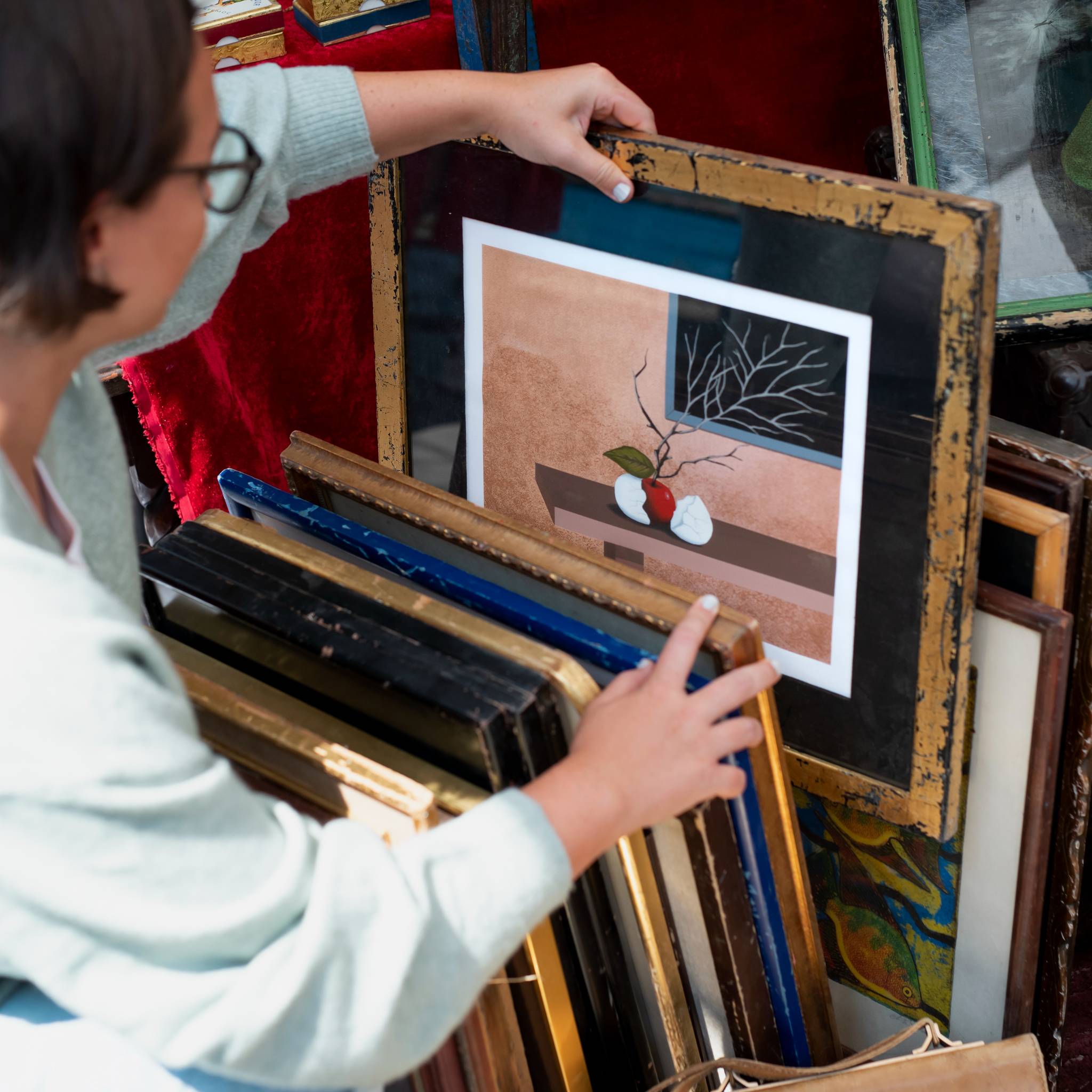 Woman looking through artworks