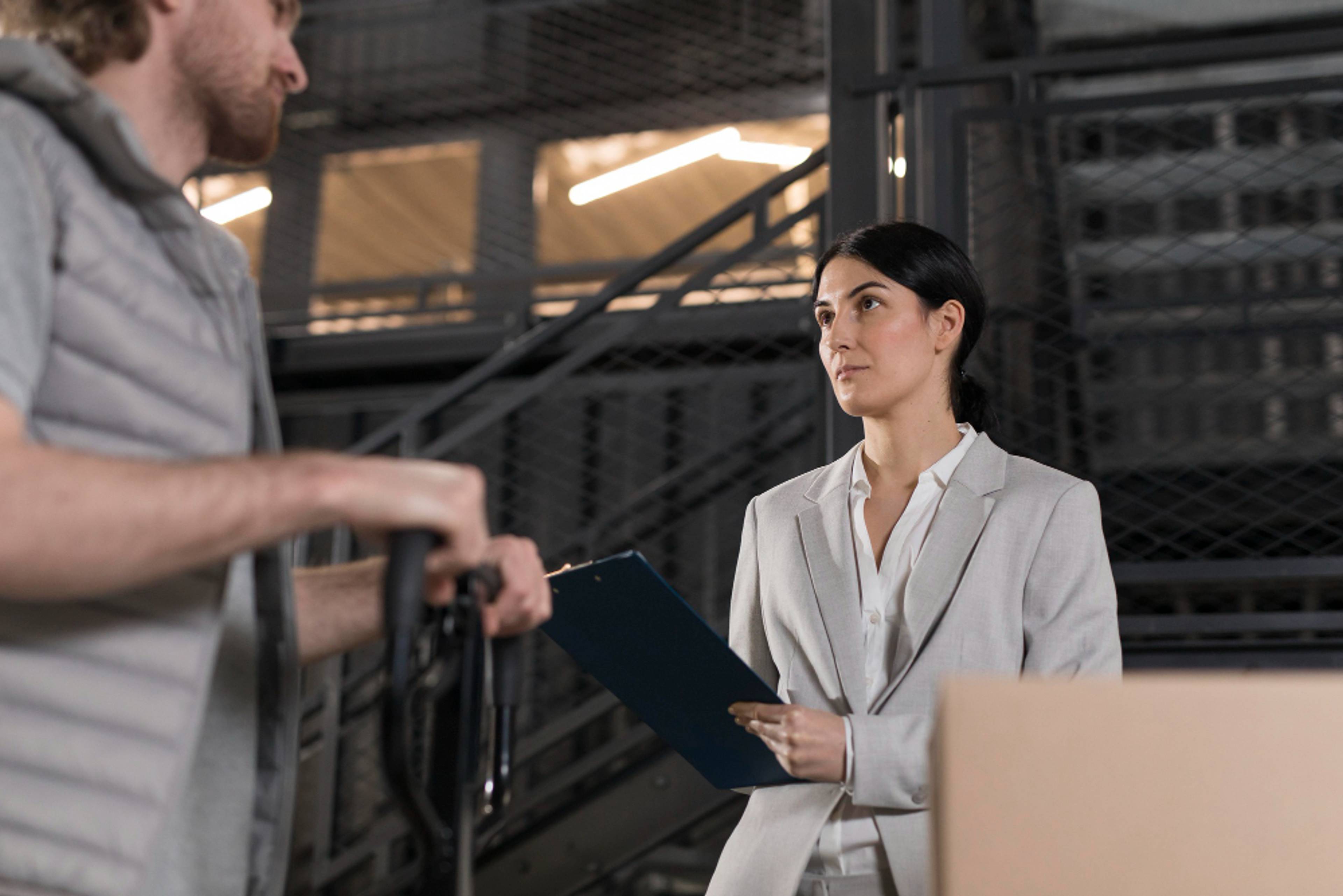 A woman checking an inventory sheet or signing for a delivery