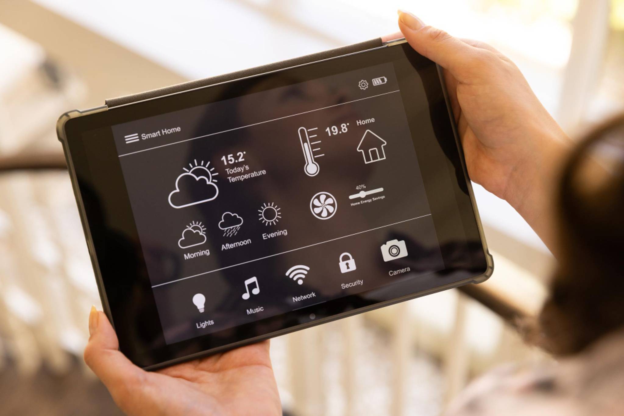 Someone using a tablet to control temperature and humidity