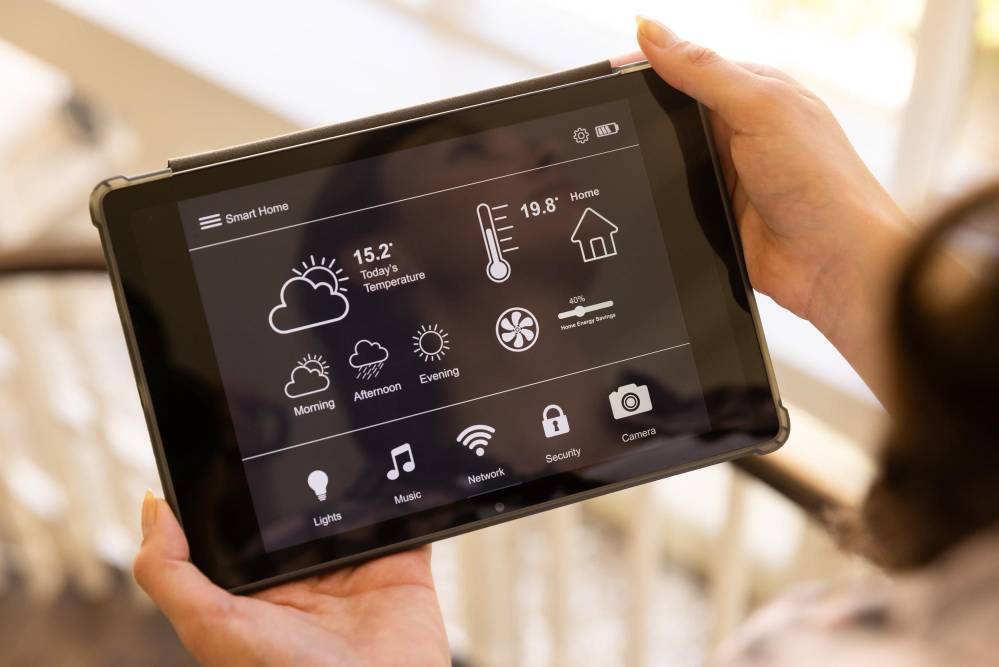 Someone using a tablet to control temperature and humidity