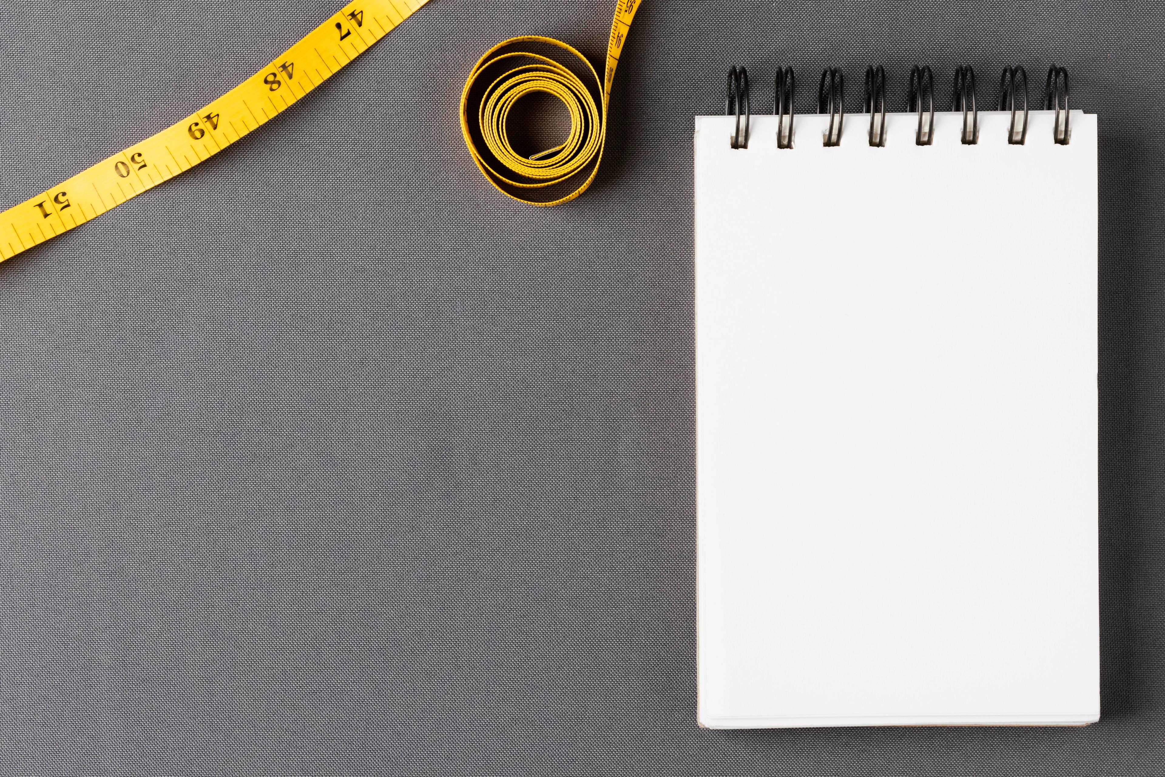 measuring tape at notepad