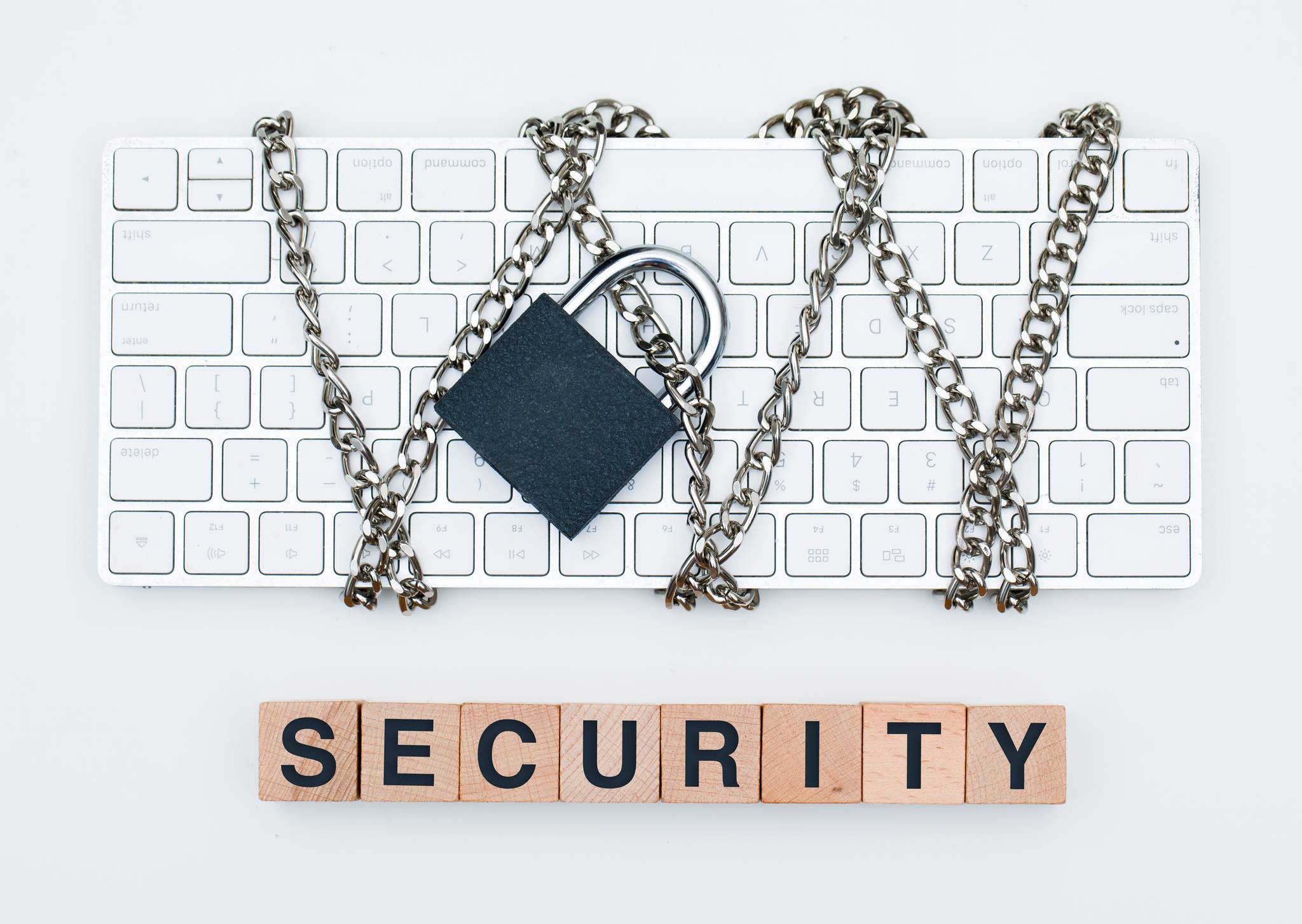 A keyboard chained with the word "security" spelled out