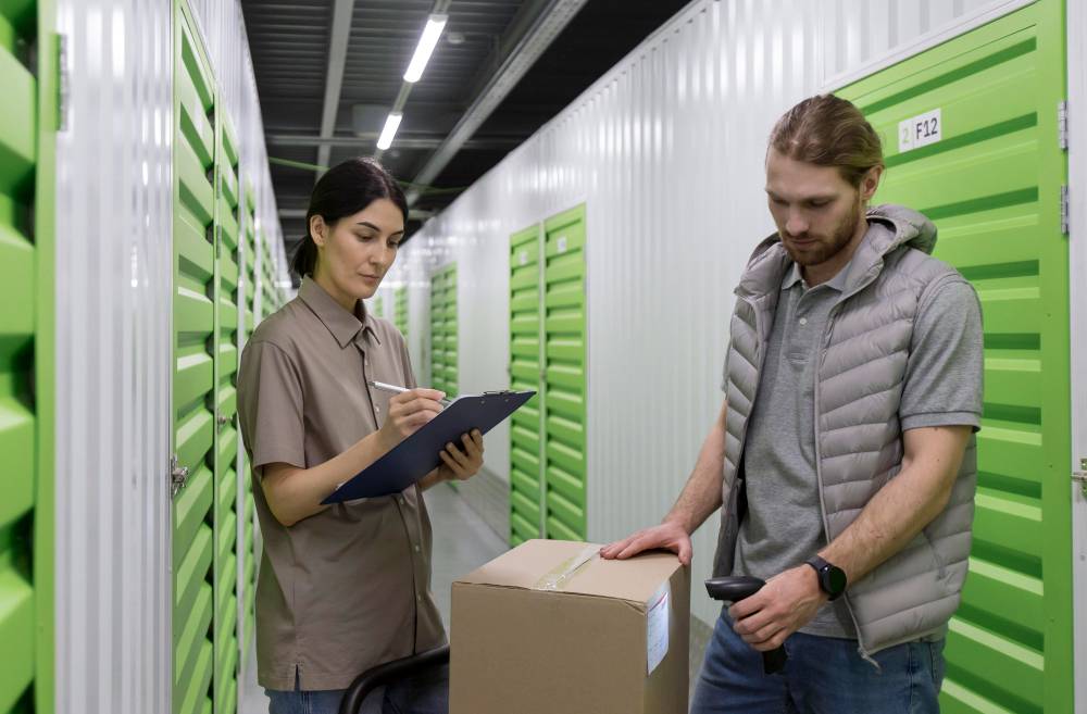 man and woman scanning boxes in storage facility