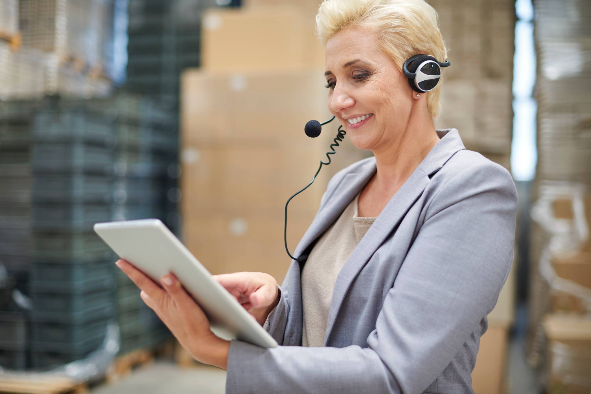 Woman holding clipboard wearing headset