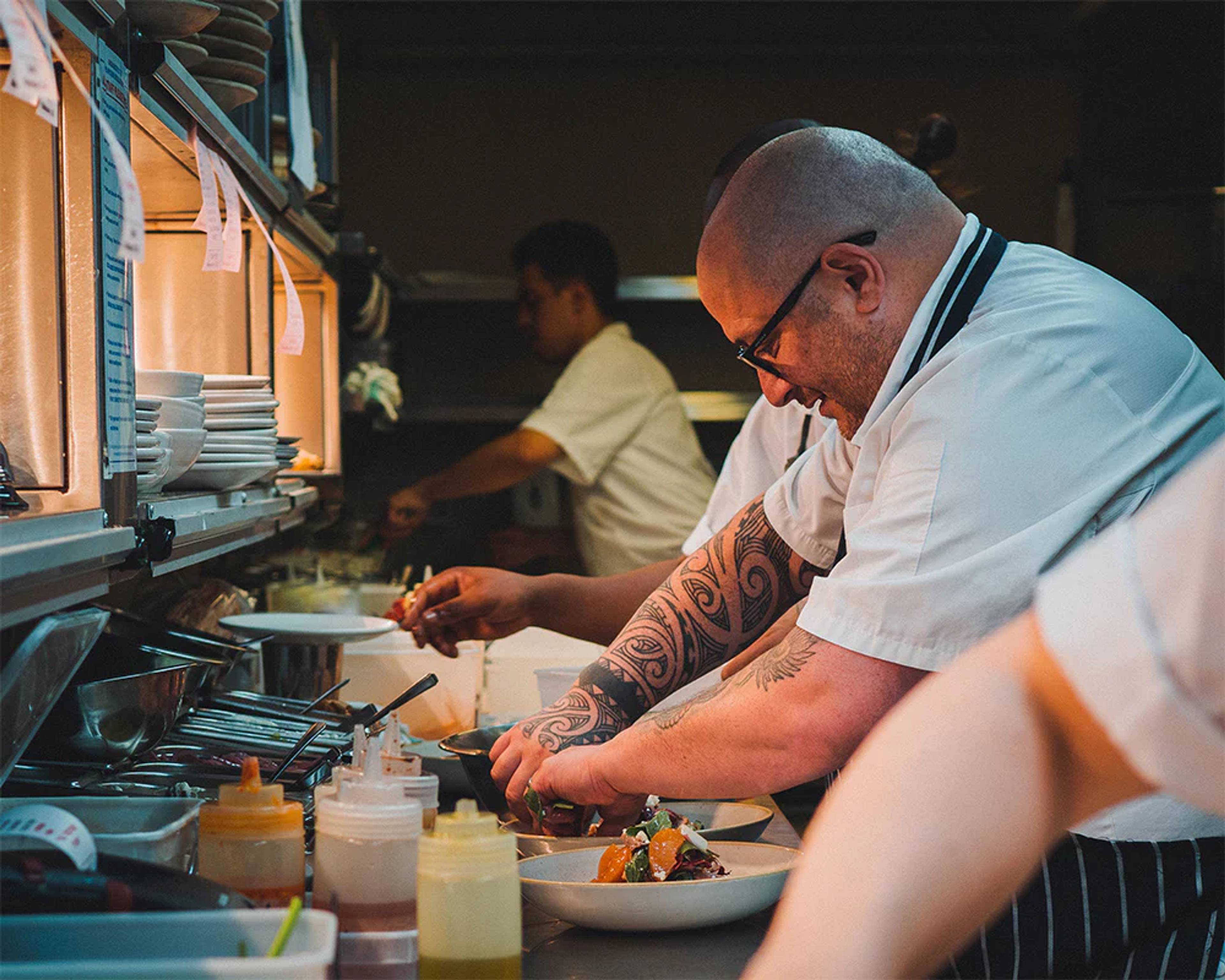 Chef preparing food at Caravan Kings Cross