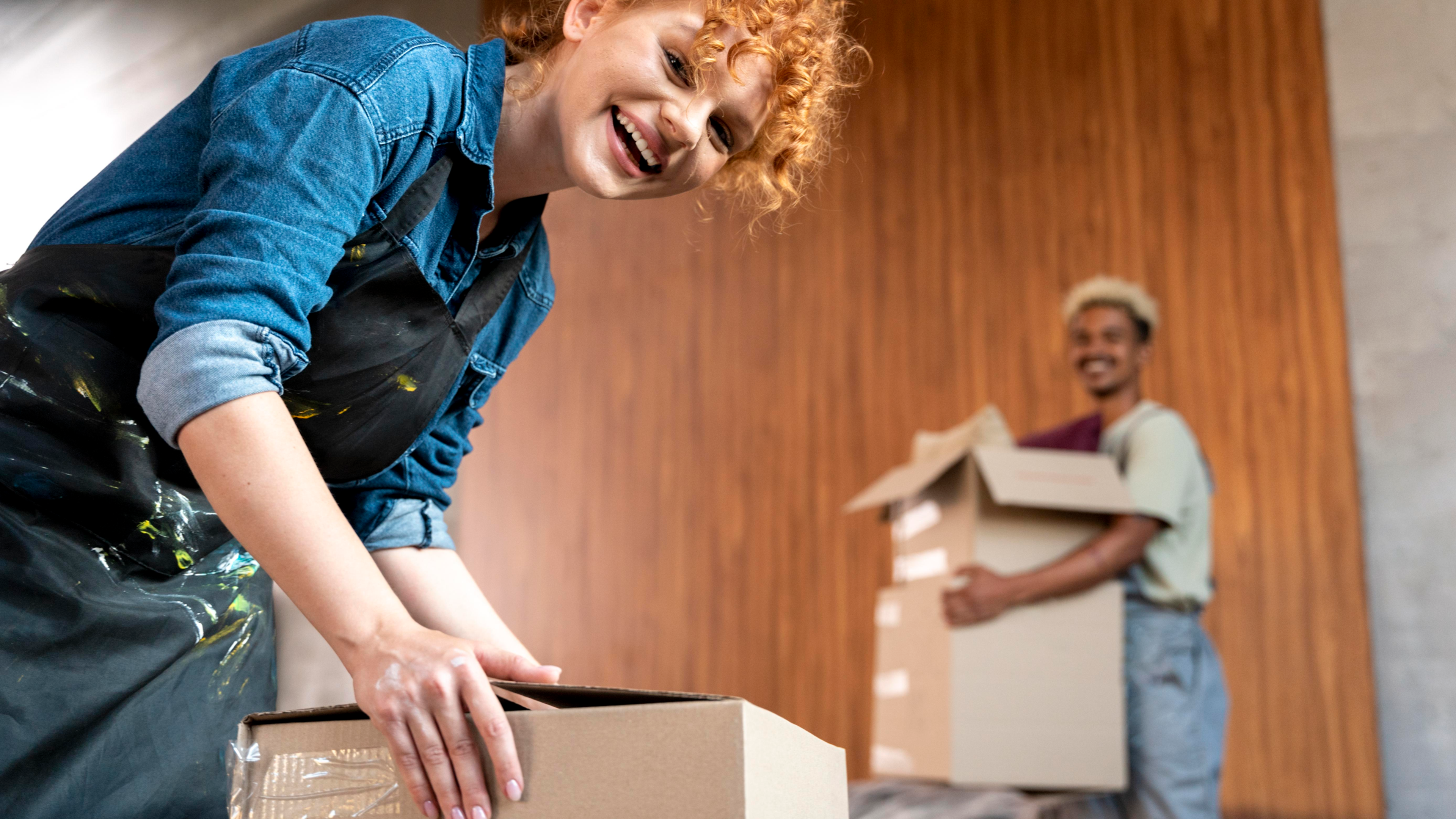 Women and man packing boxes