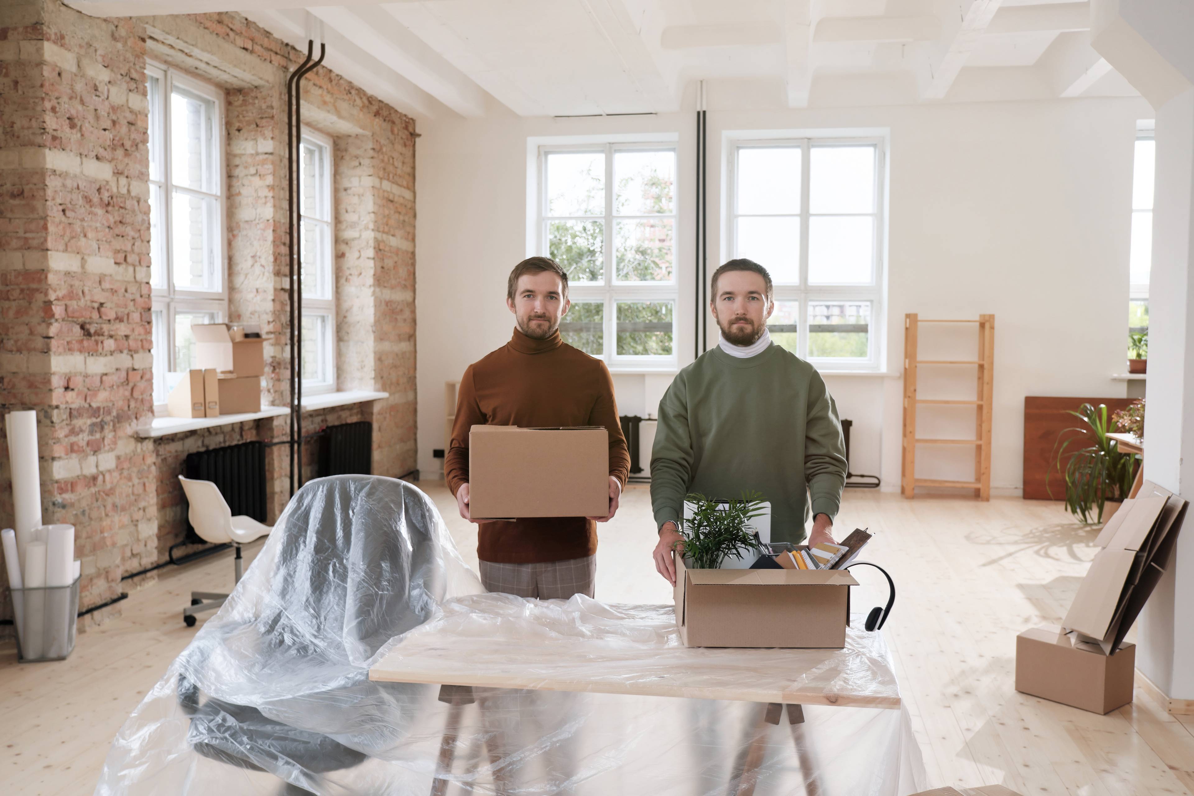 two brothers opening an office with boxes