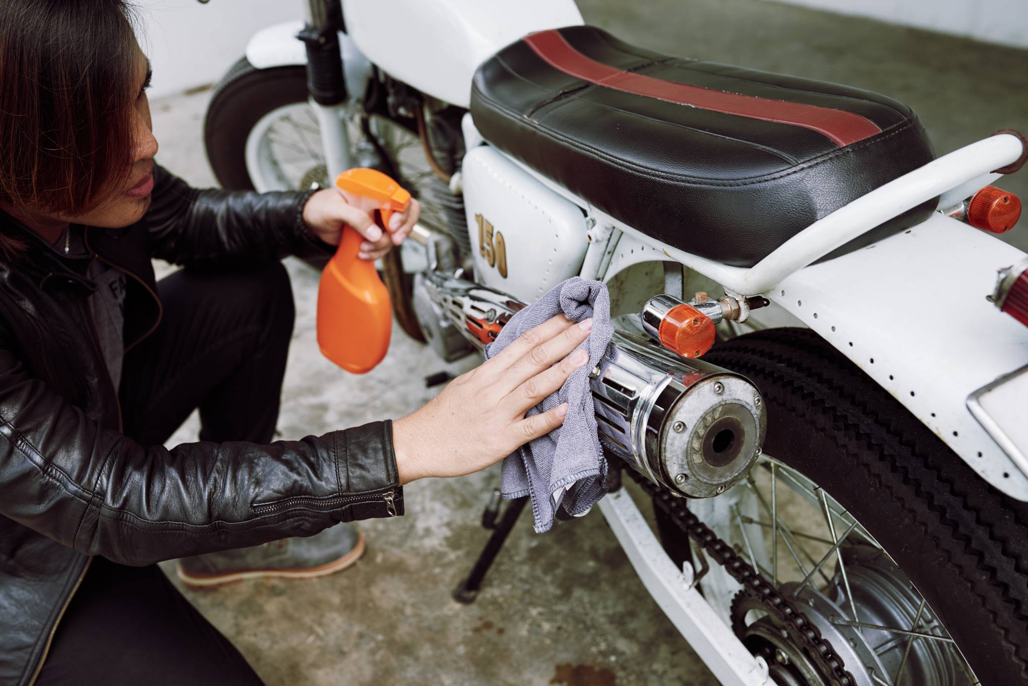 woman polishing motorbike