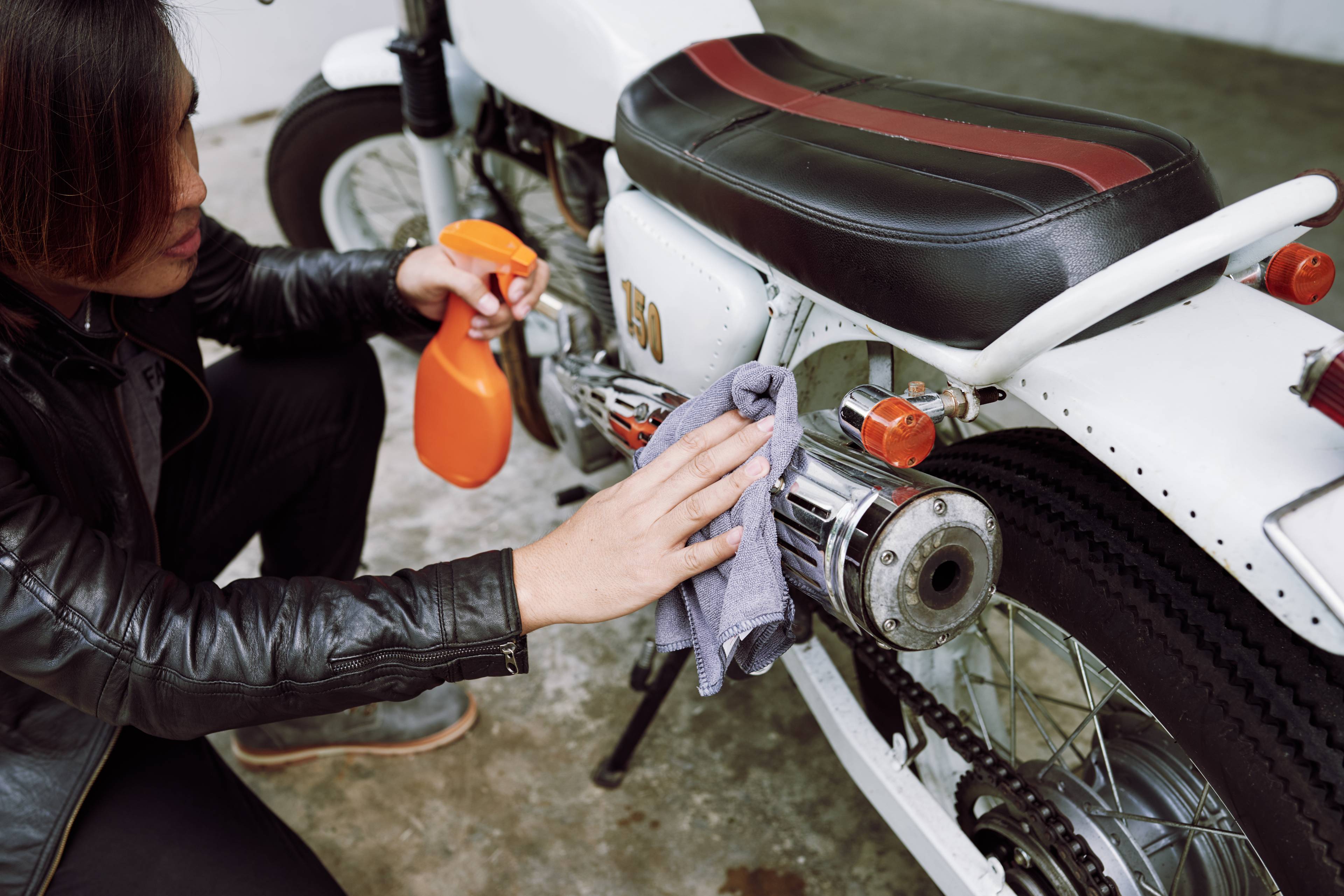 woman polishing motorbike
