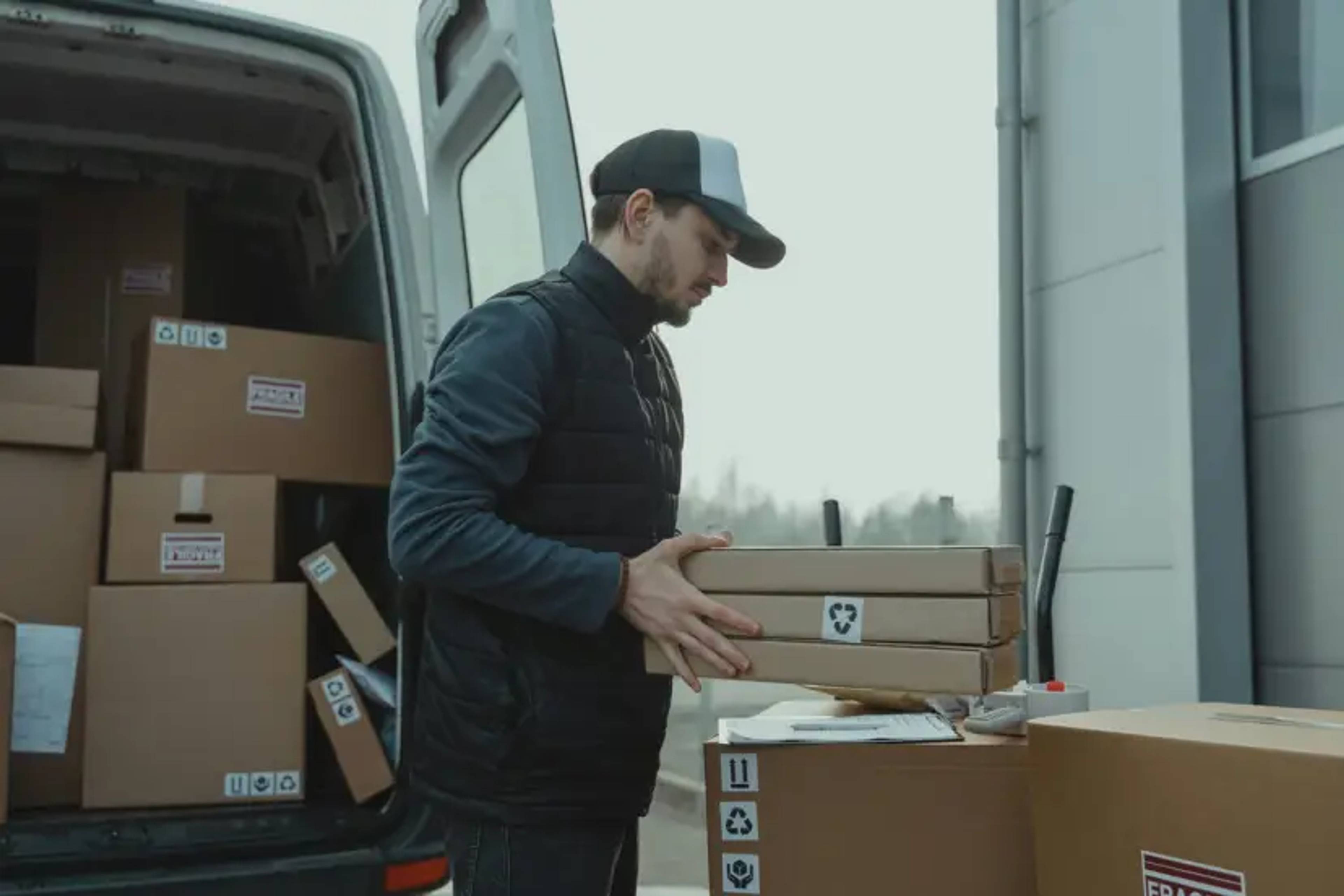 Man packing van with boxes