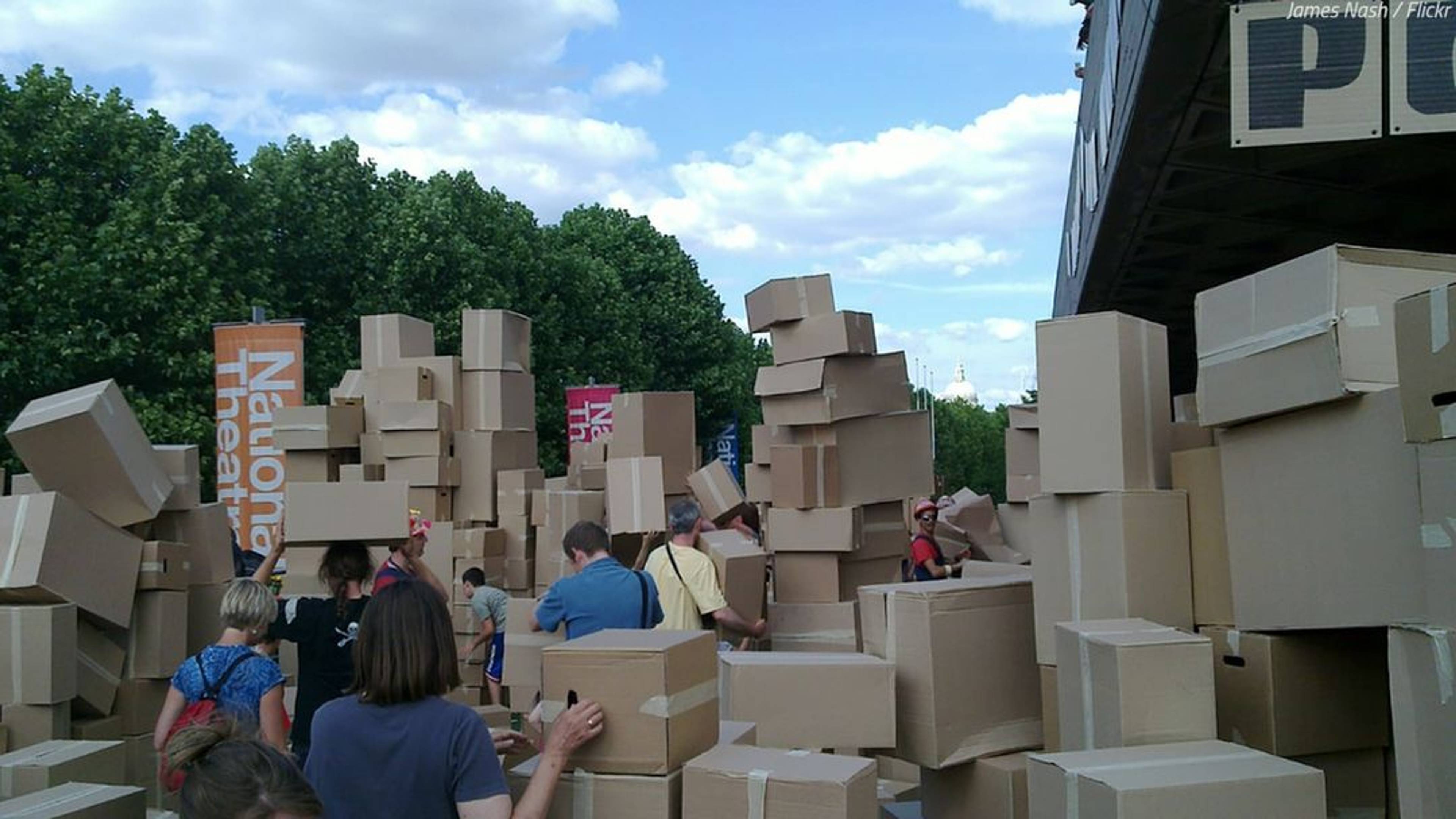 People sifting through many cardboard boxes