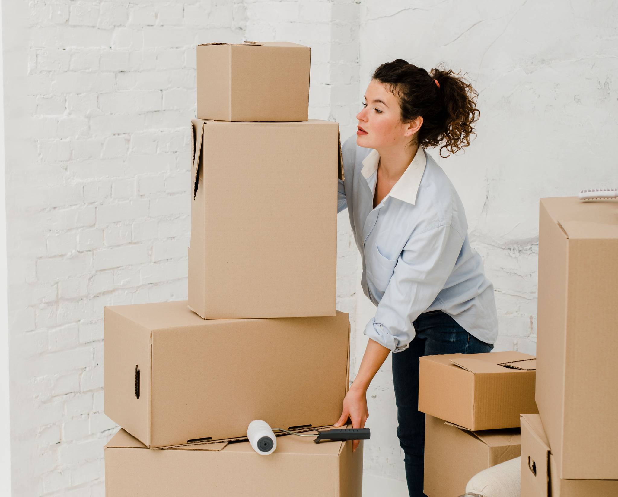 woman stacking carboard boxes