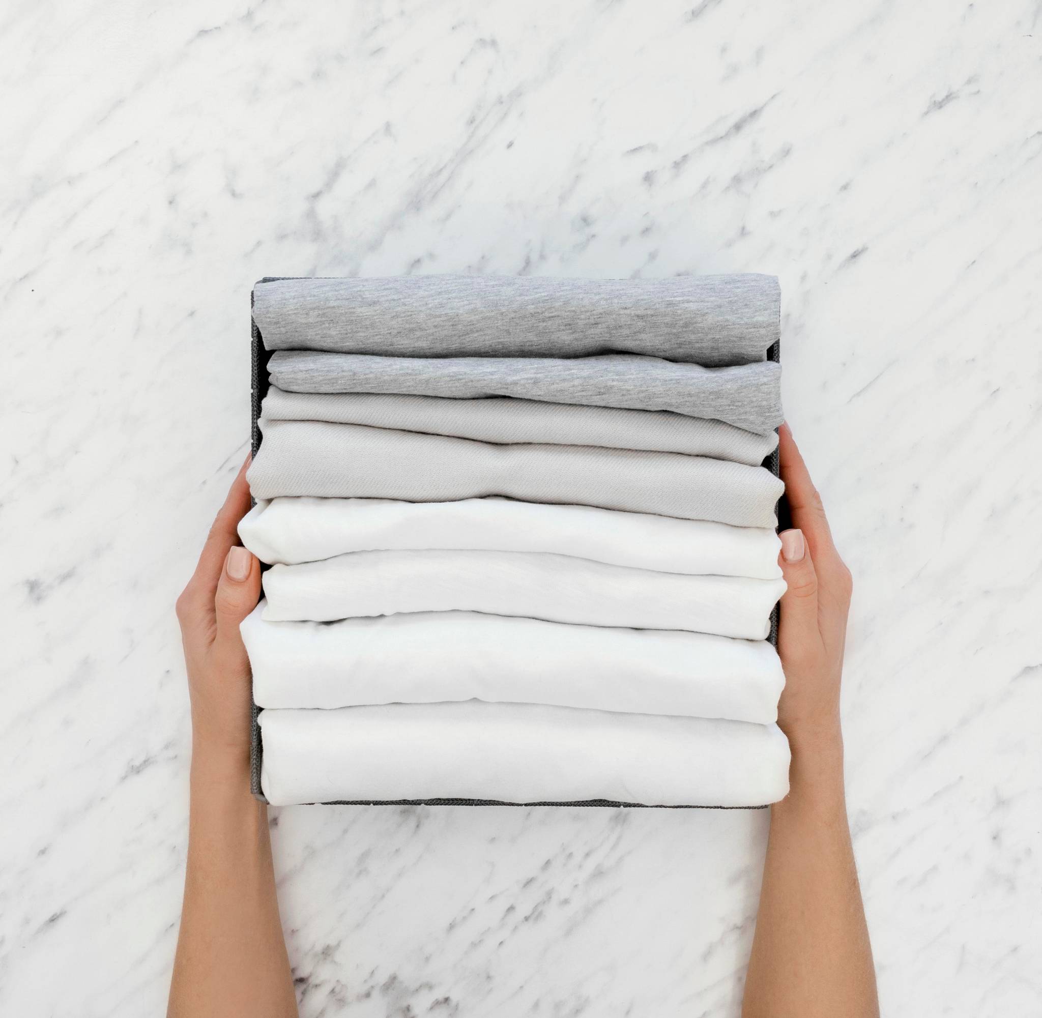 Top view of person with stack of folded linen