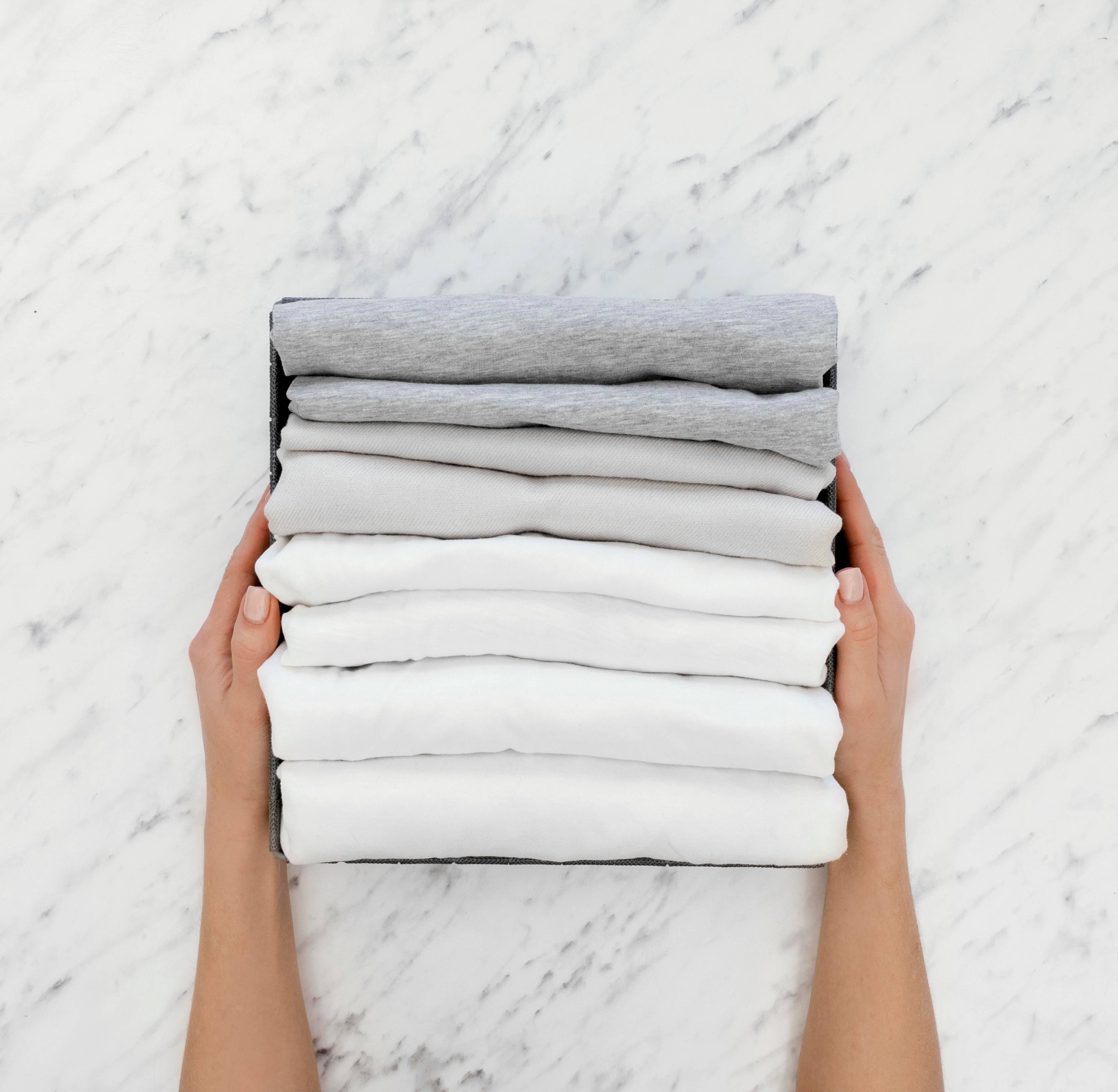 Top view of person with stack of folded linen
