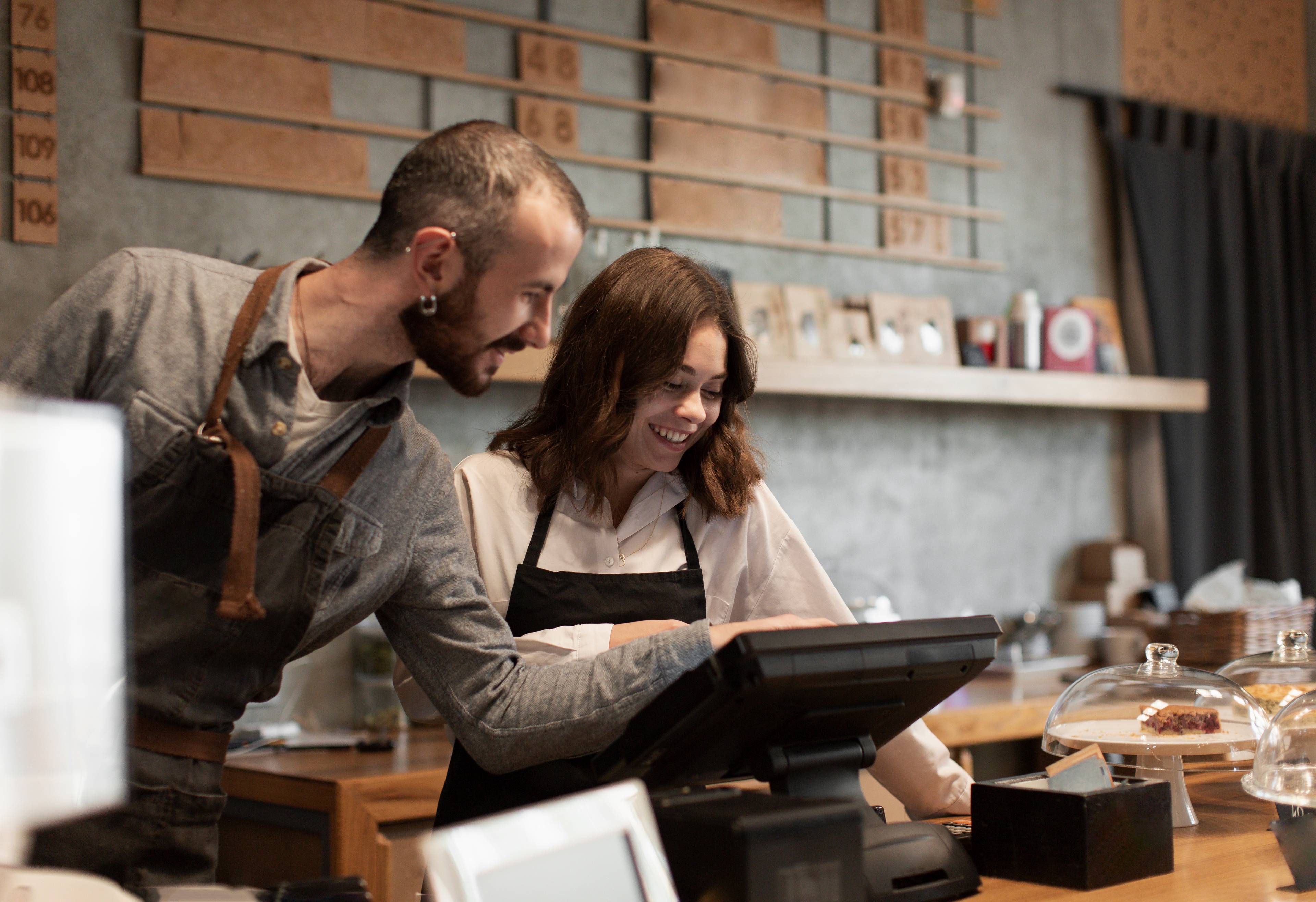 Smiling man and woman at cash register