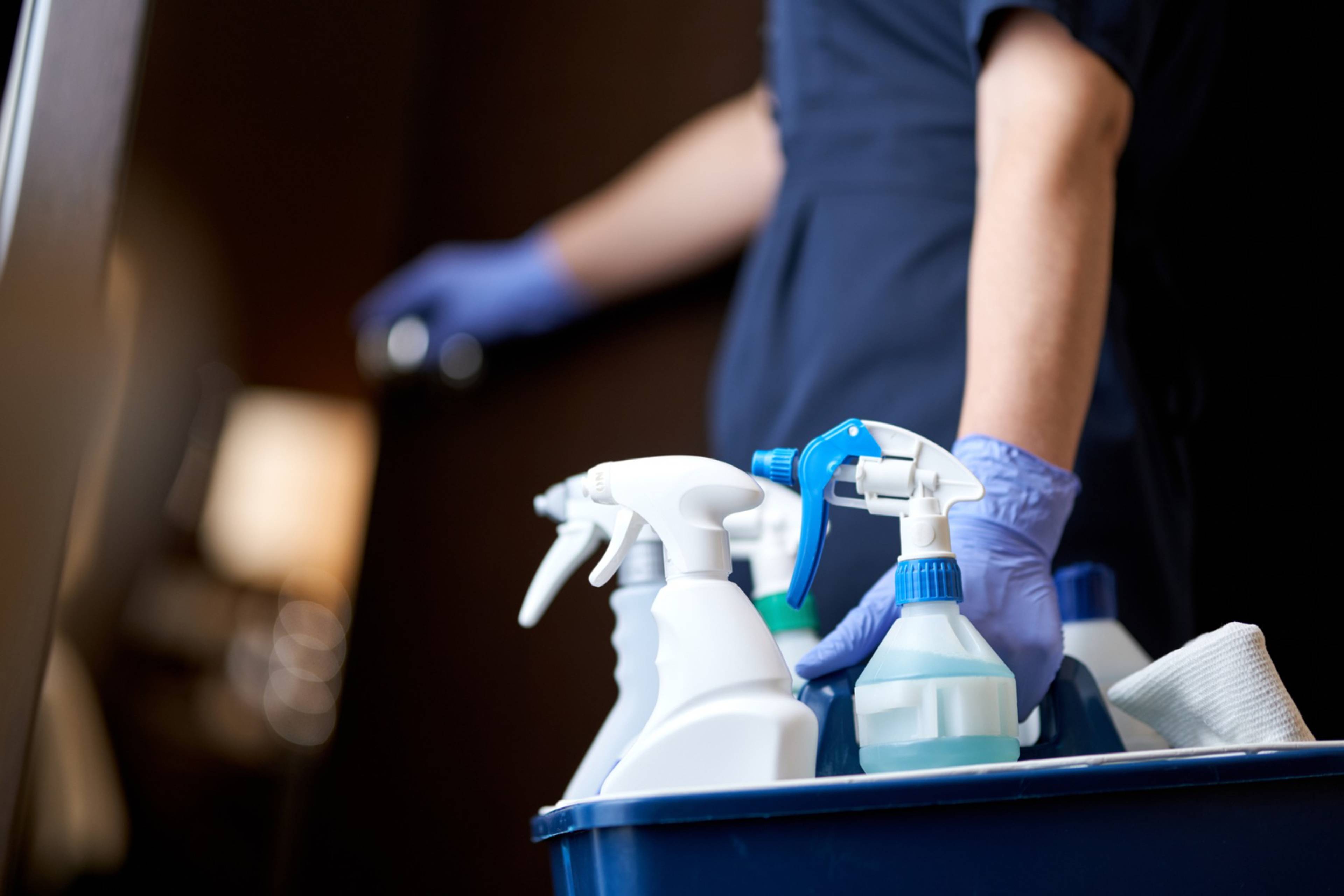 man holding cleaning products 