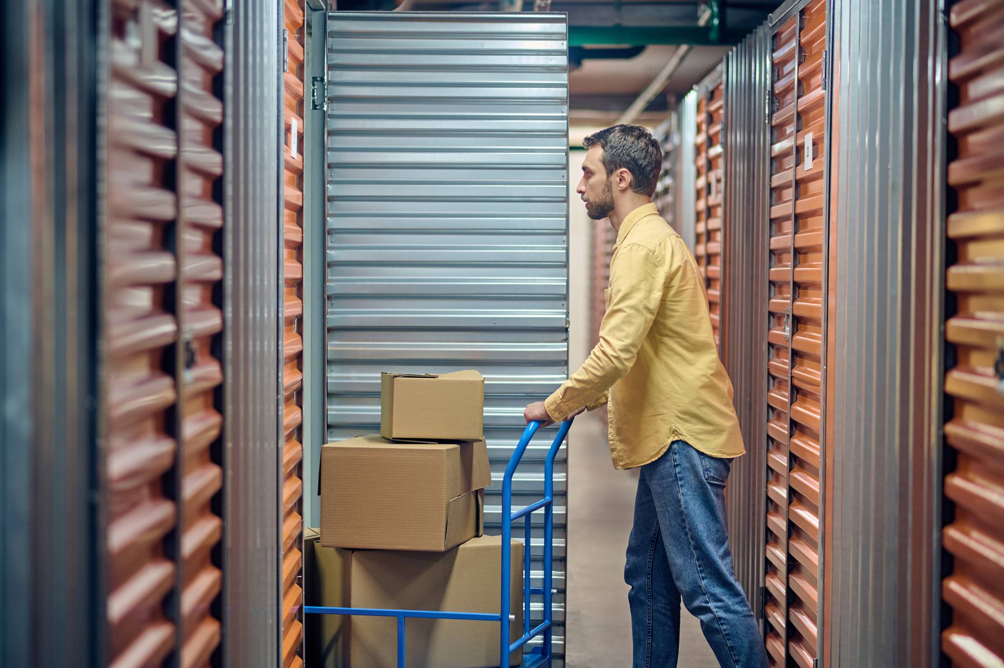Man with boxes in self storage