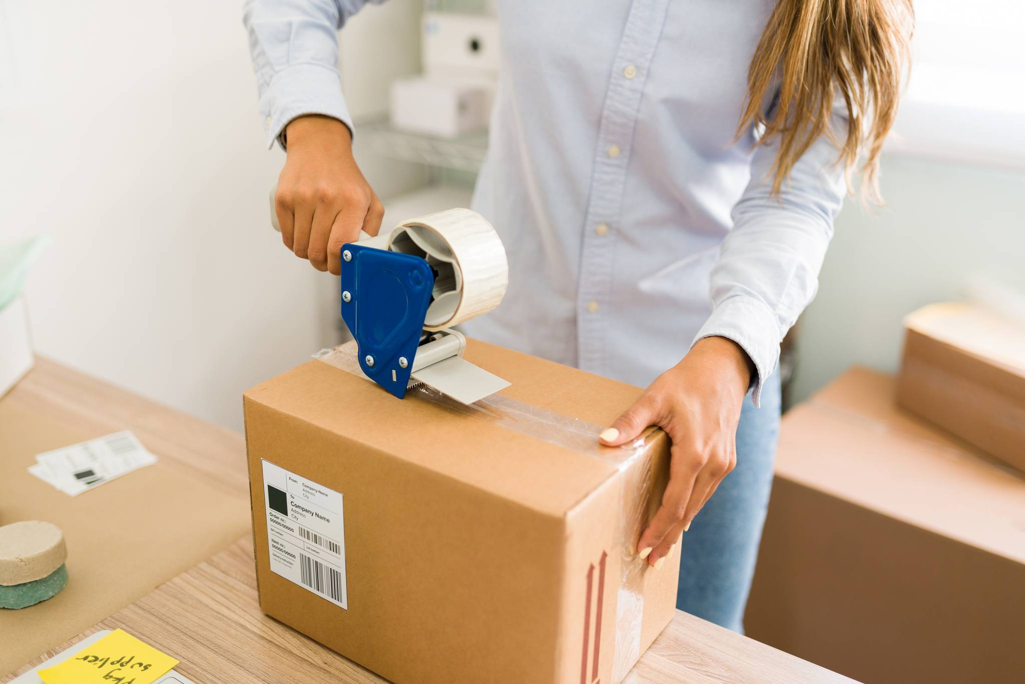 A person labelling boxes