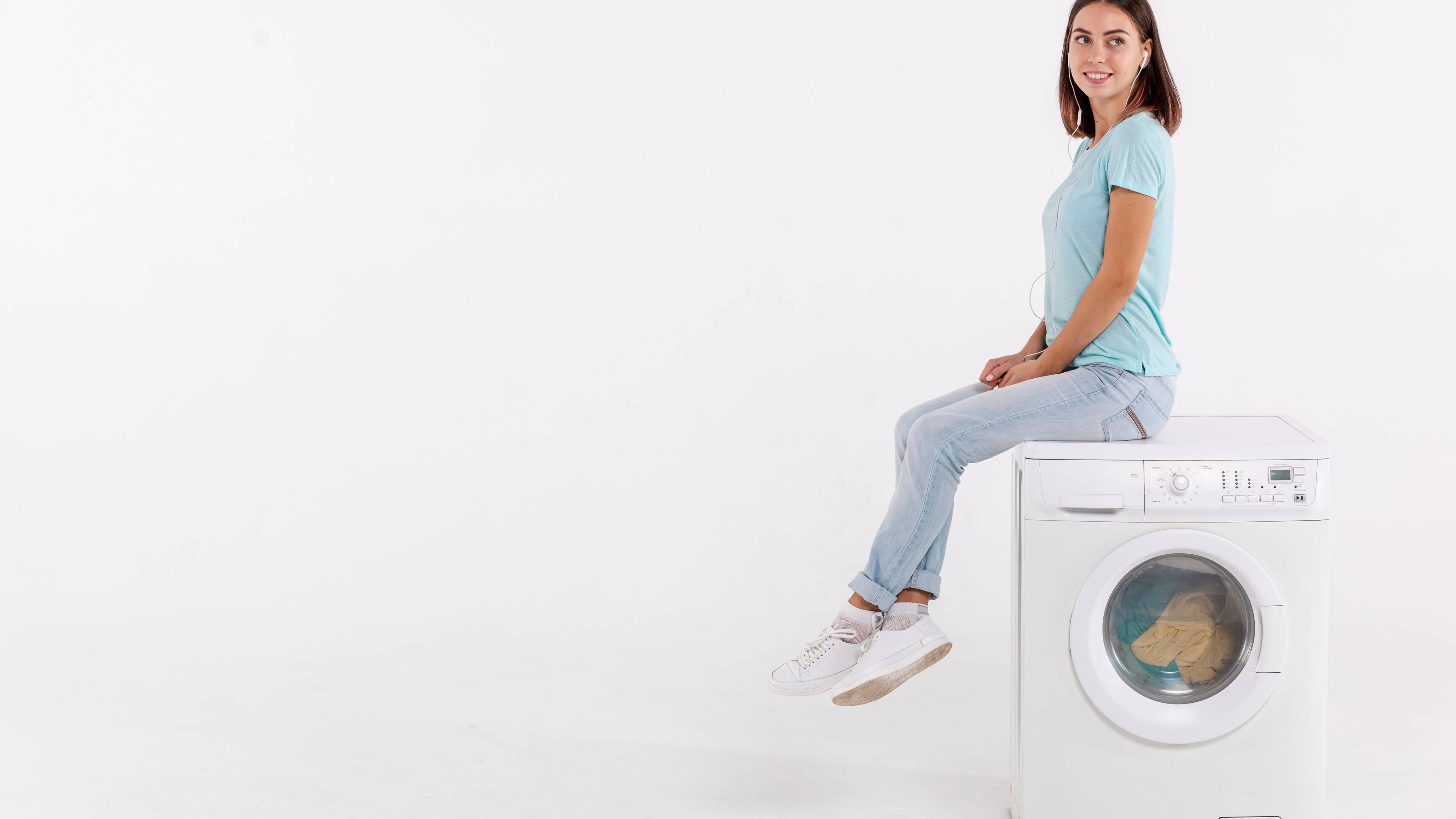 Full shot woman posing on washing machine