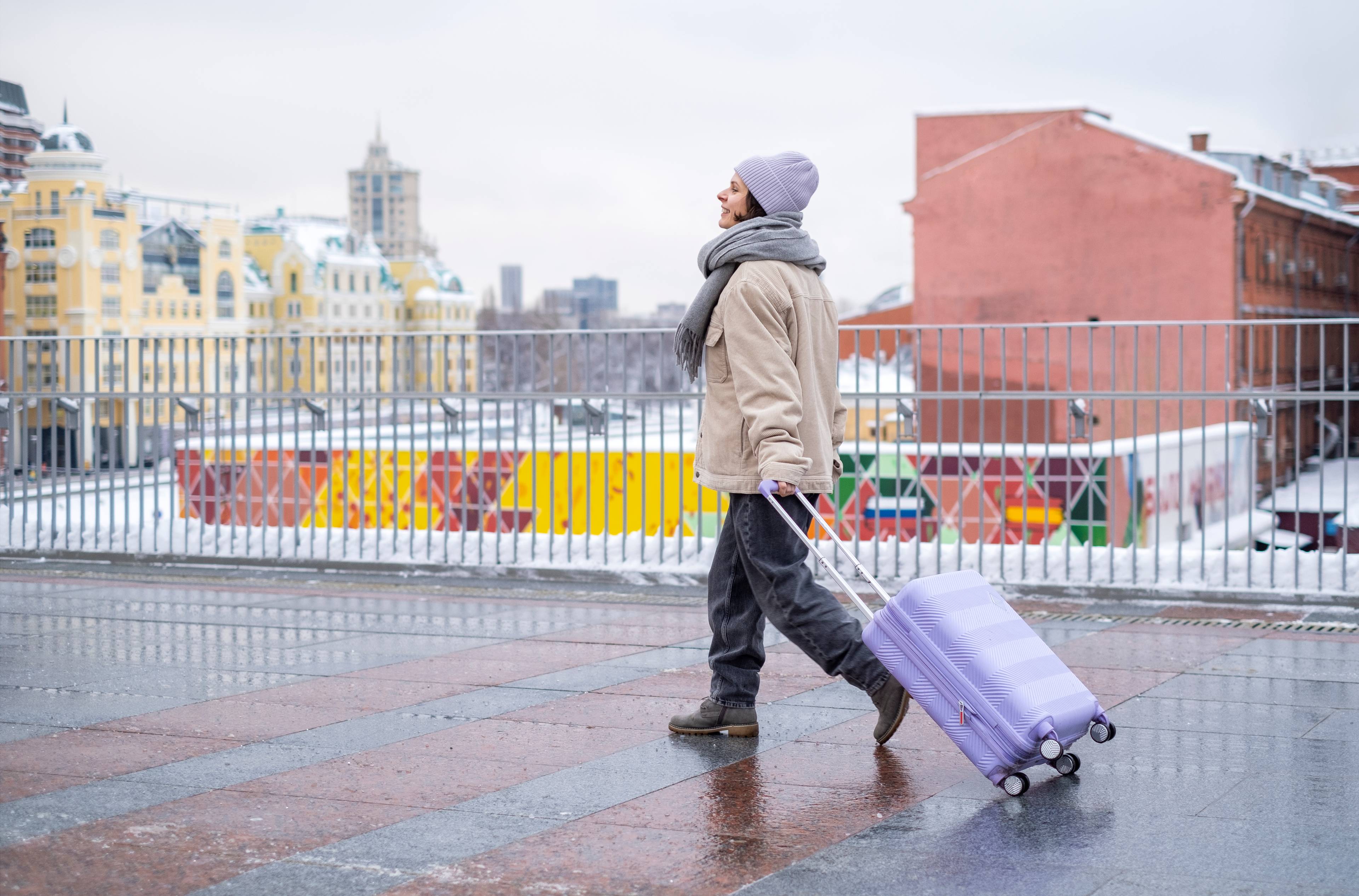woman with luggage on london street