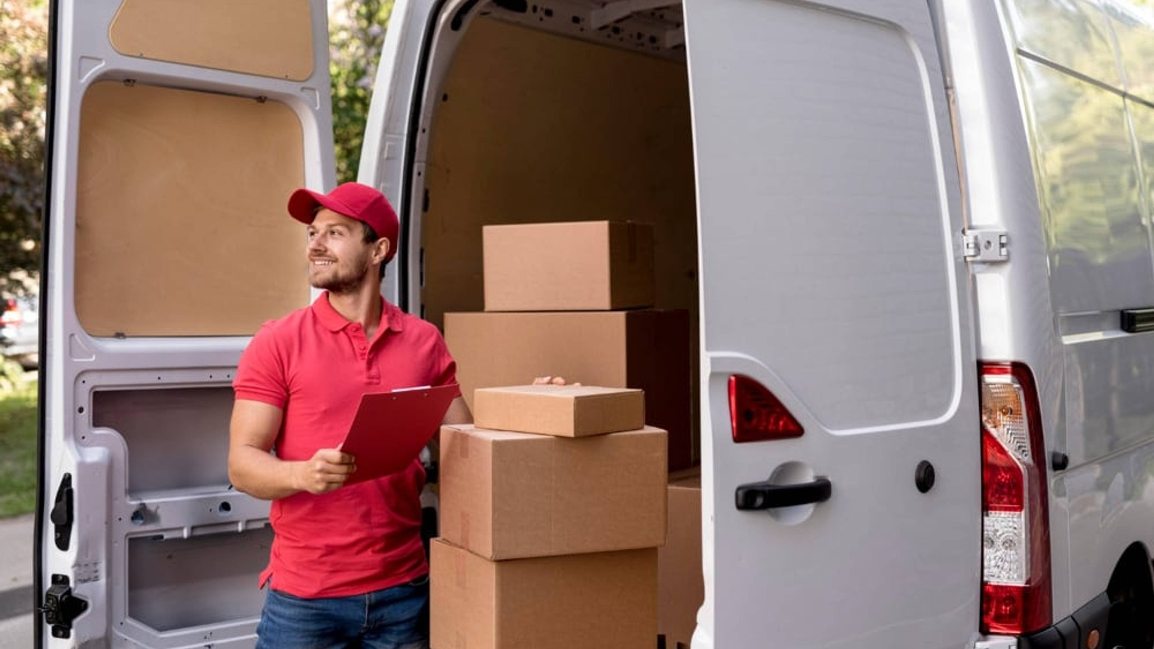Delivery man loading boxes into a van