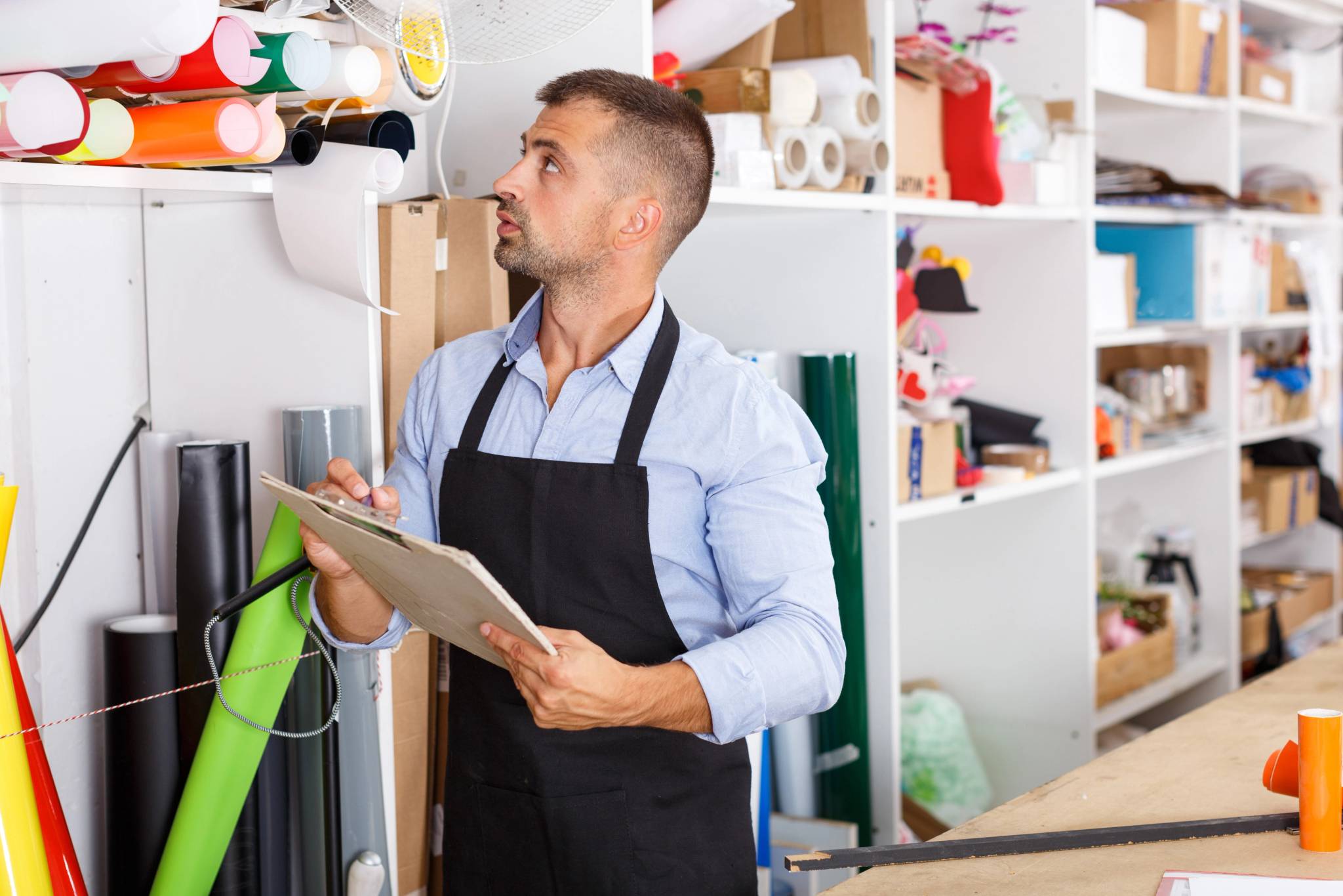 Man looking around supplies in a warehouse