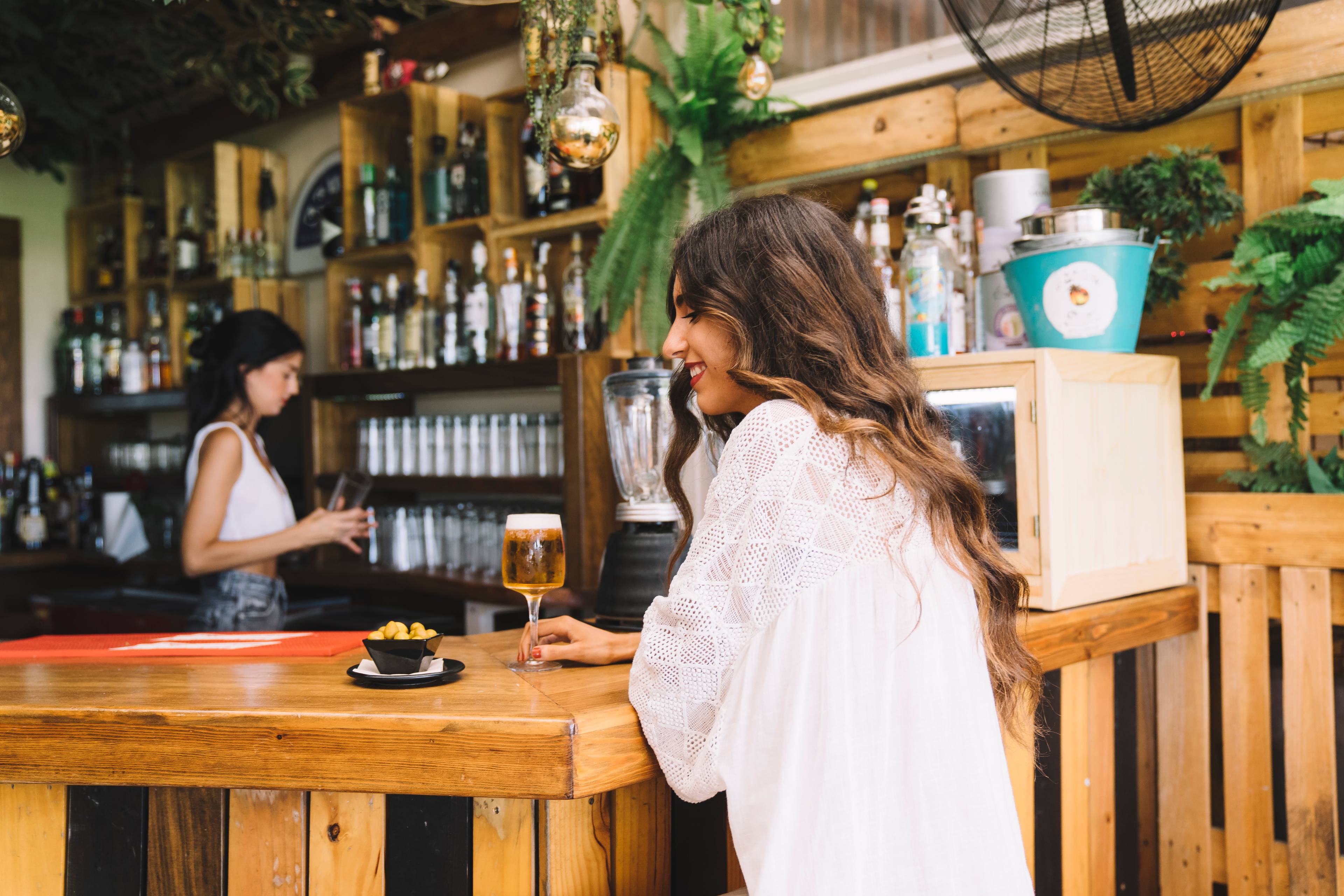 Woman with beer at bar