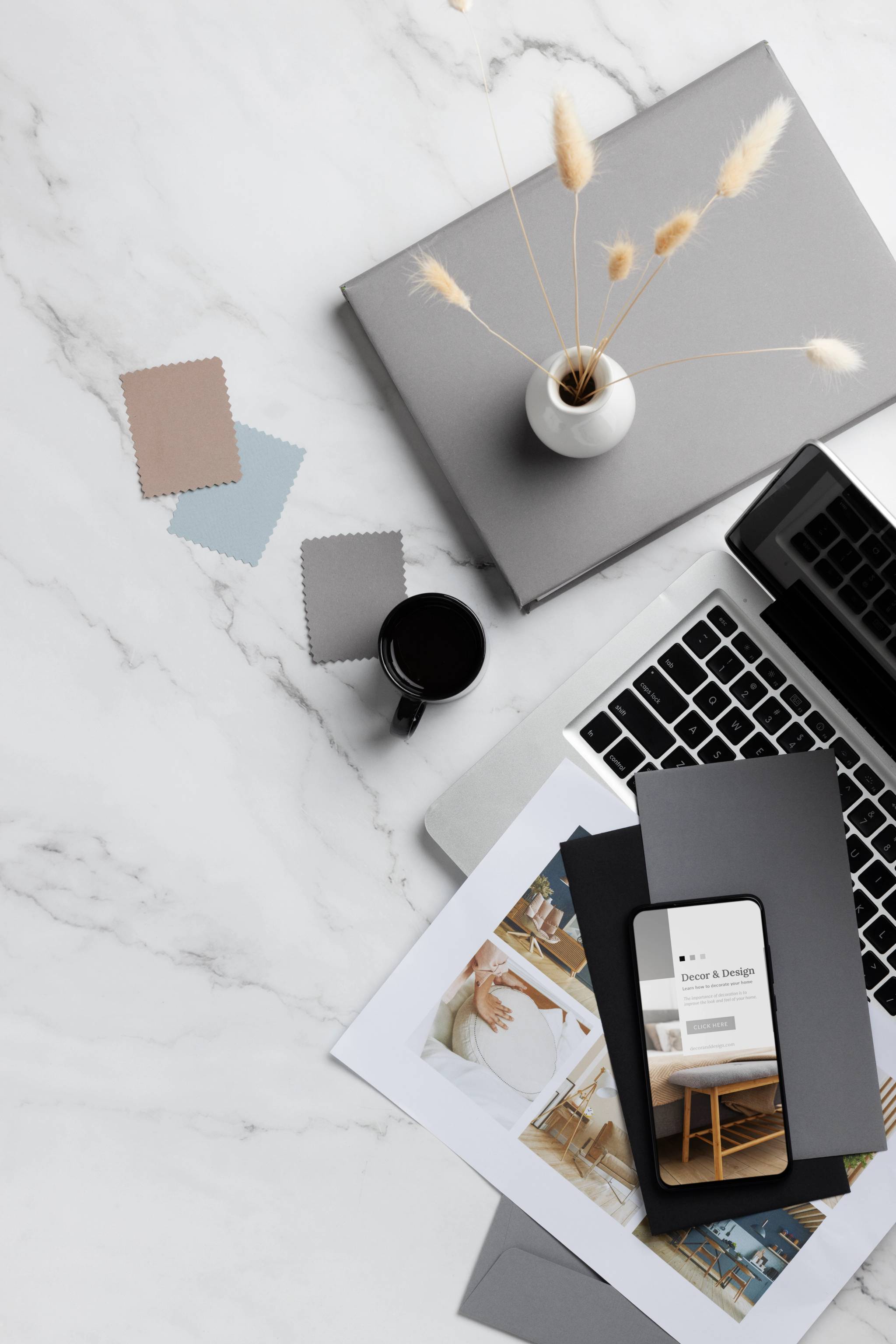 Top view of a desktop with a laptop, a phone, and a bunch of post its.