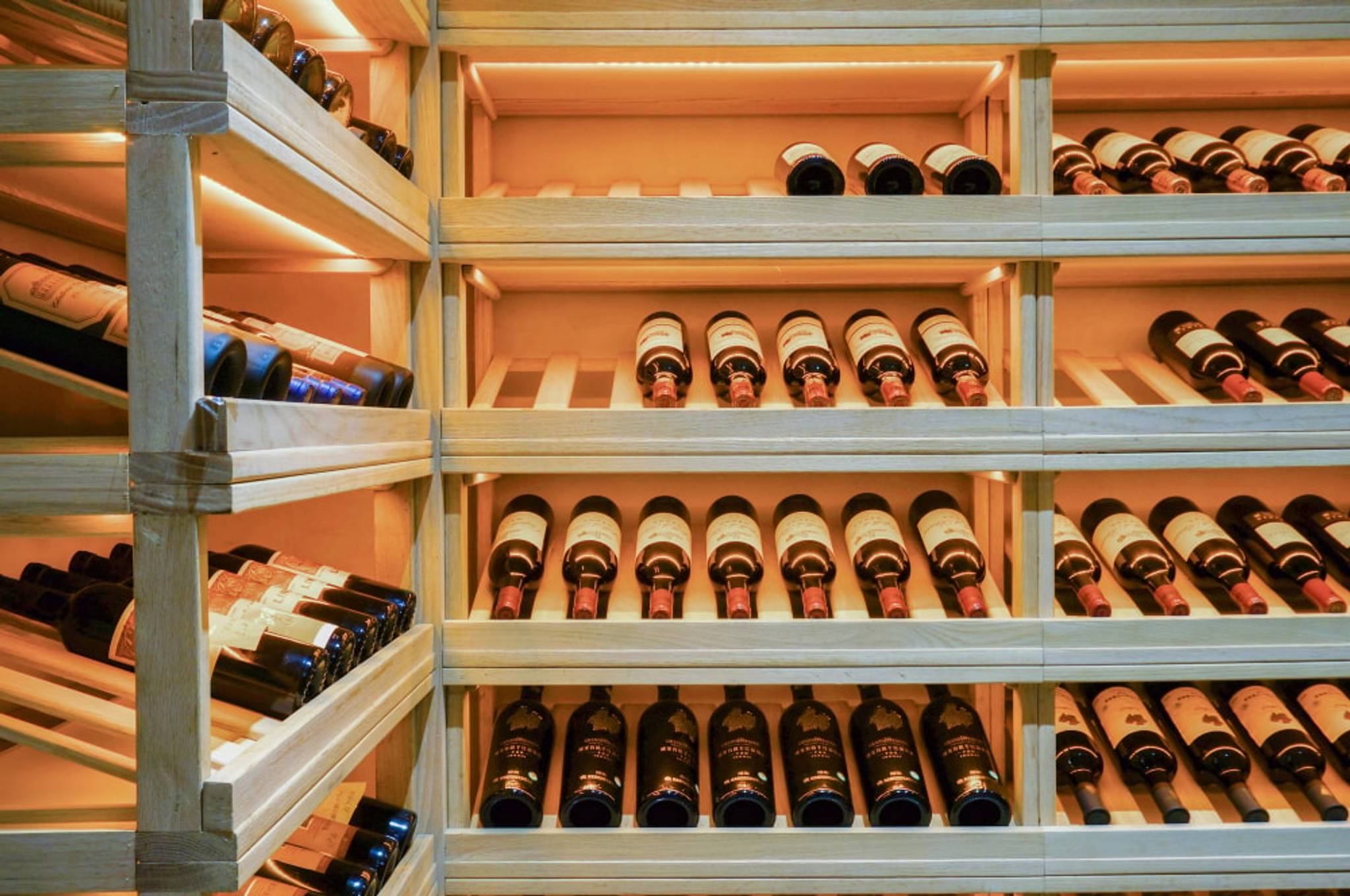 A wine rack filled with bottles of red wine