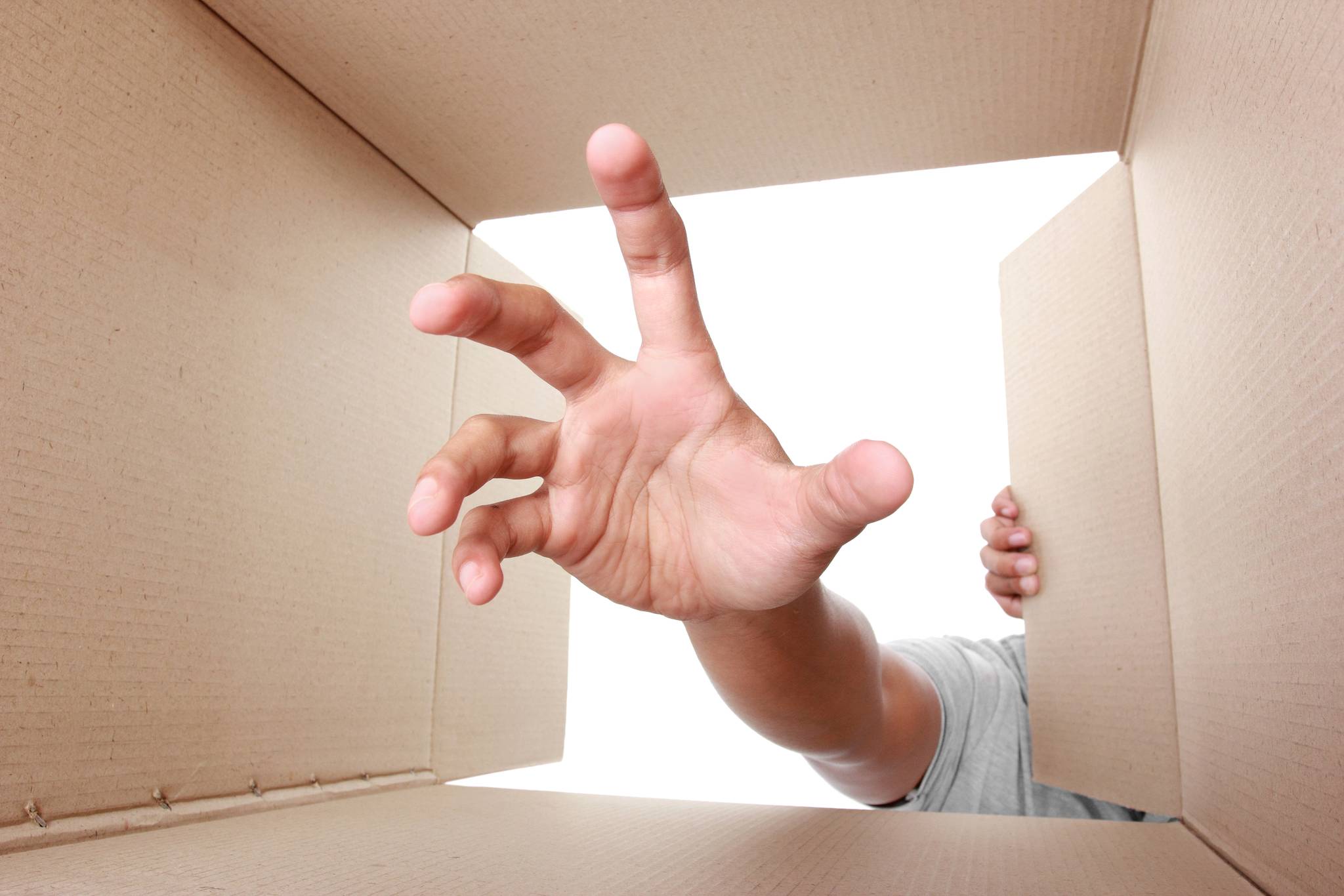 Hand taking something out of box