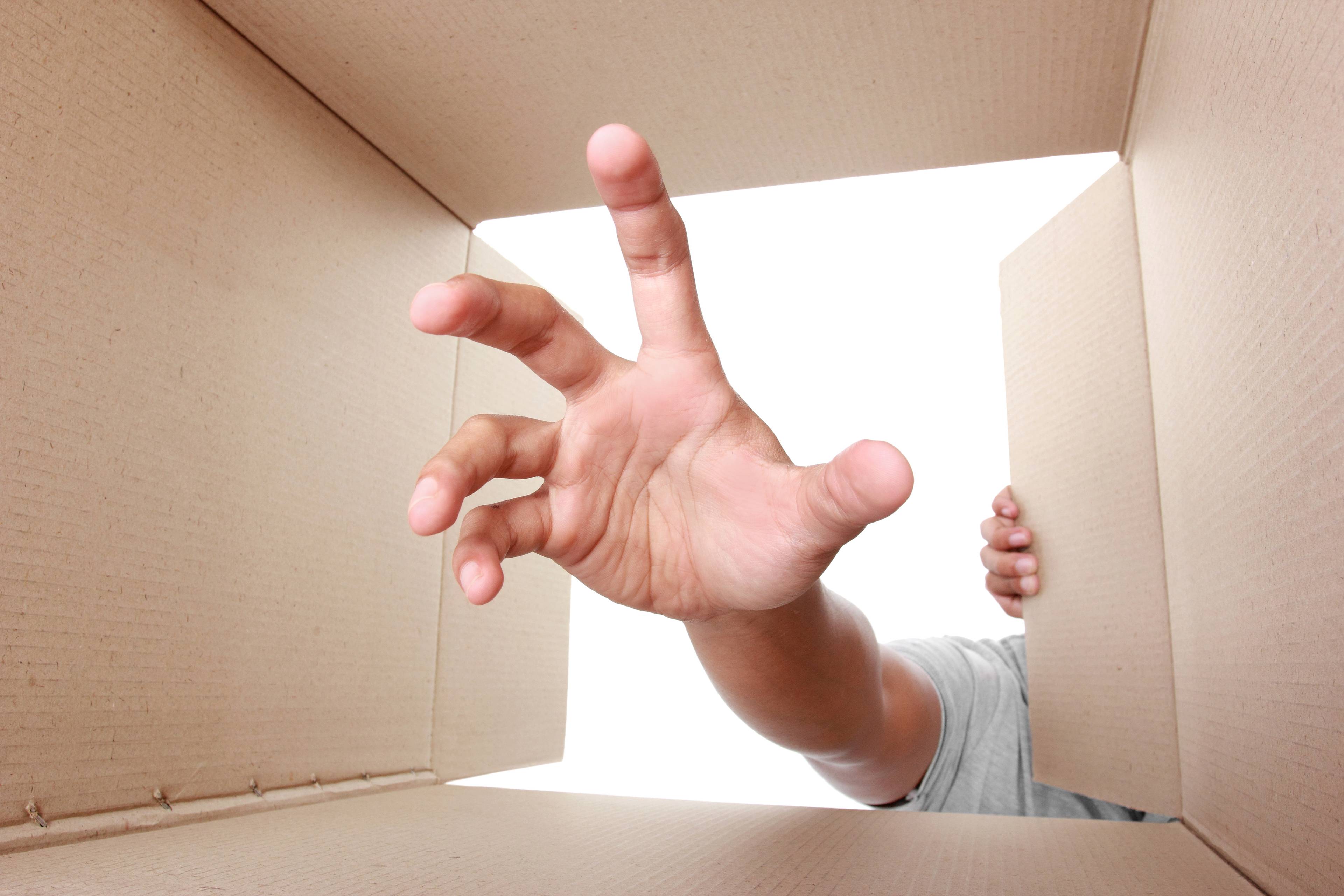 Hand taking something out of box