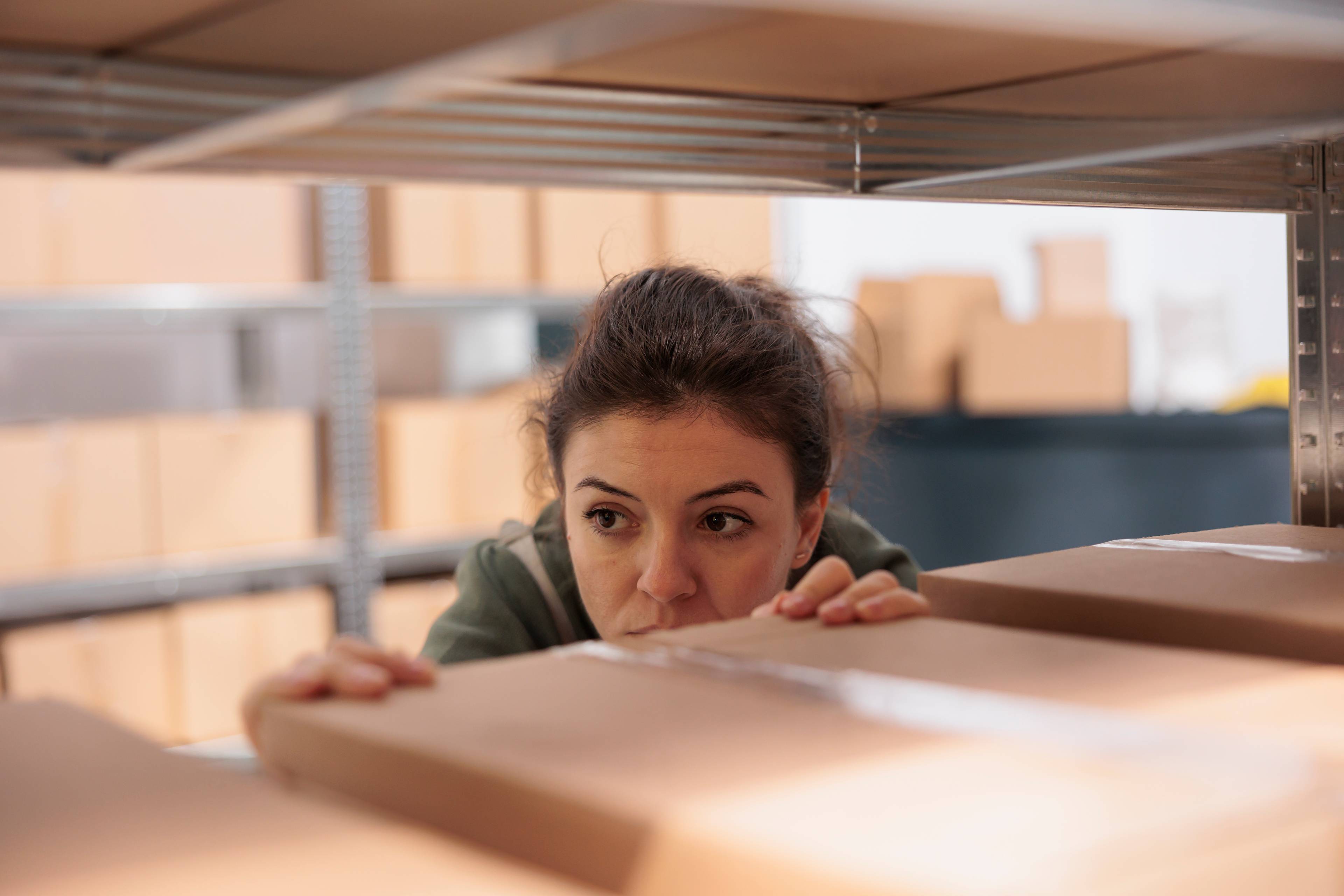Woman checking stored boxes