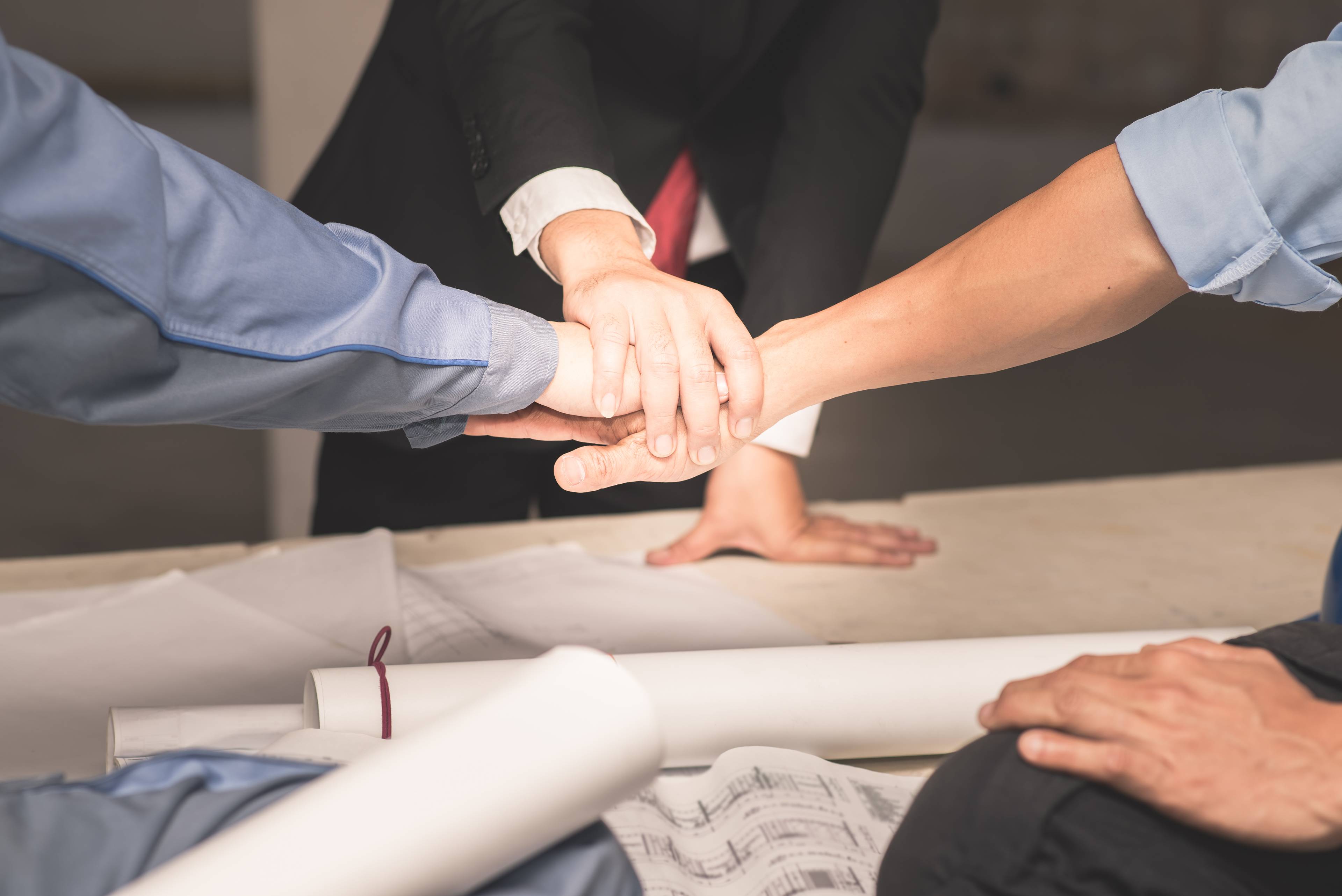 Hands collaborating signifying teamwork.