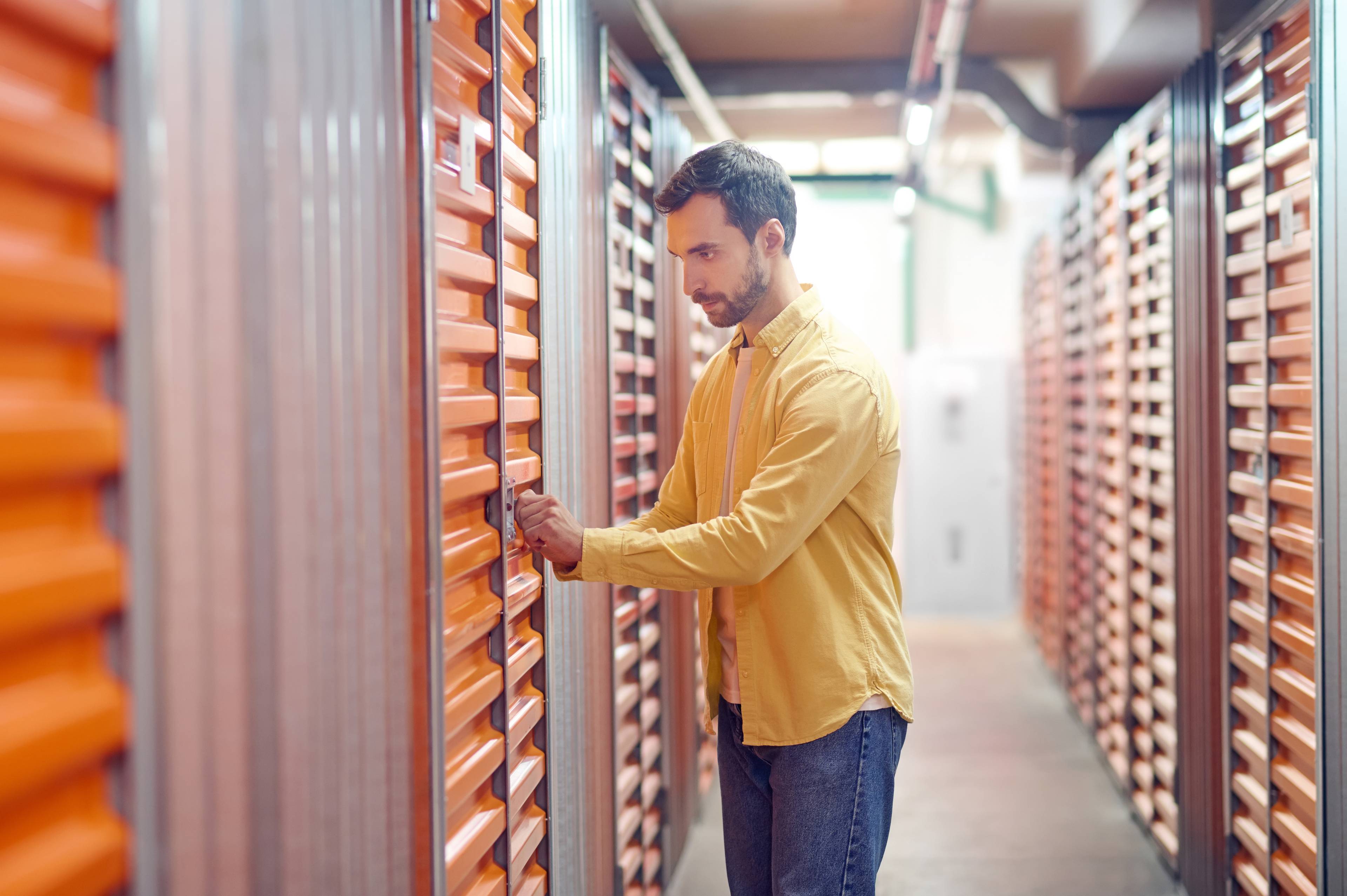 man checking lock on storage unit