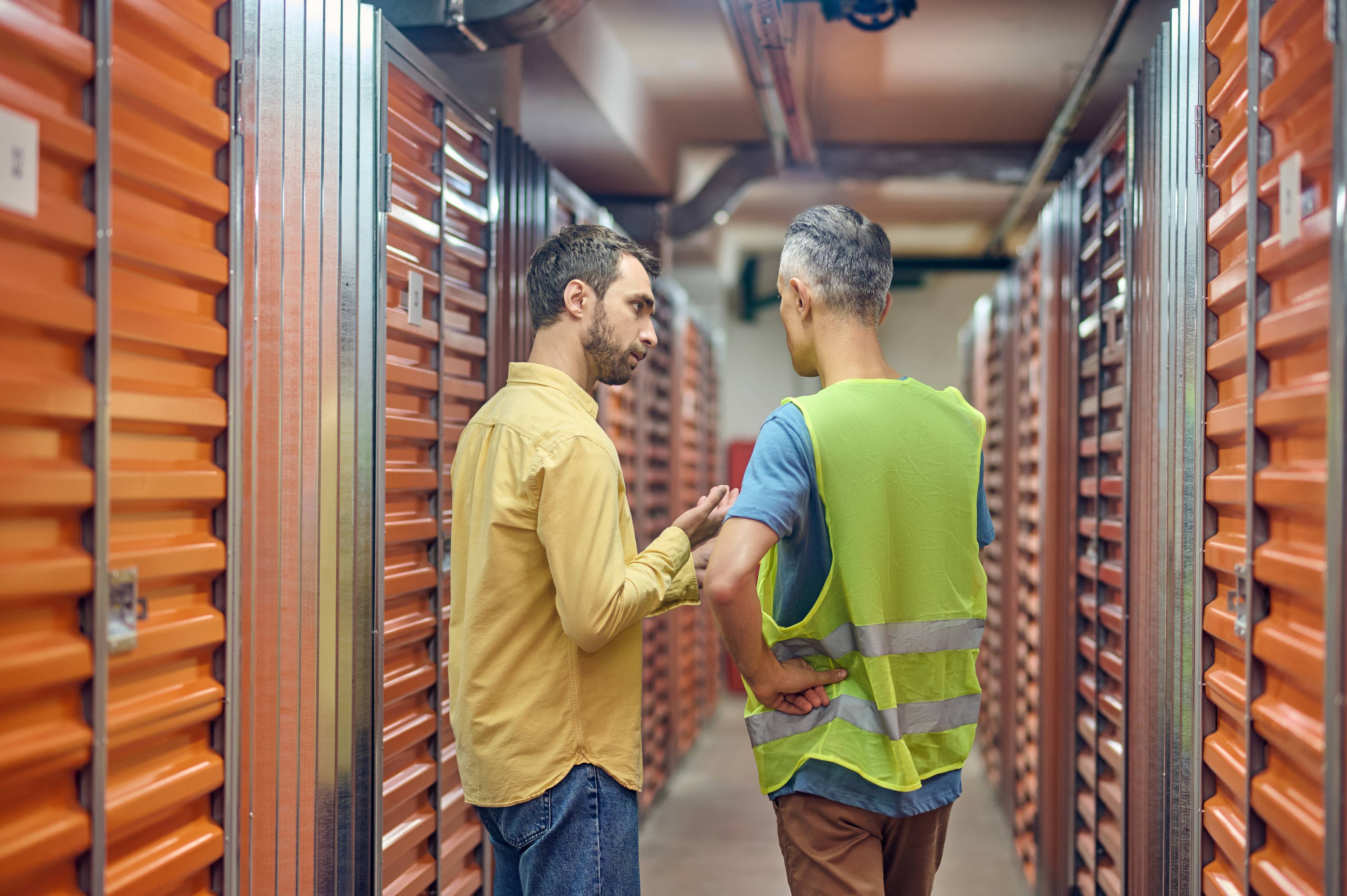 Man with worker in storage facility