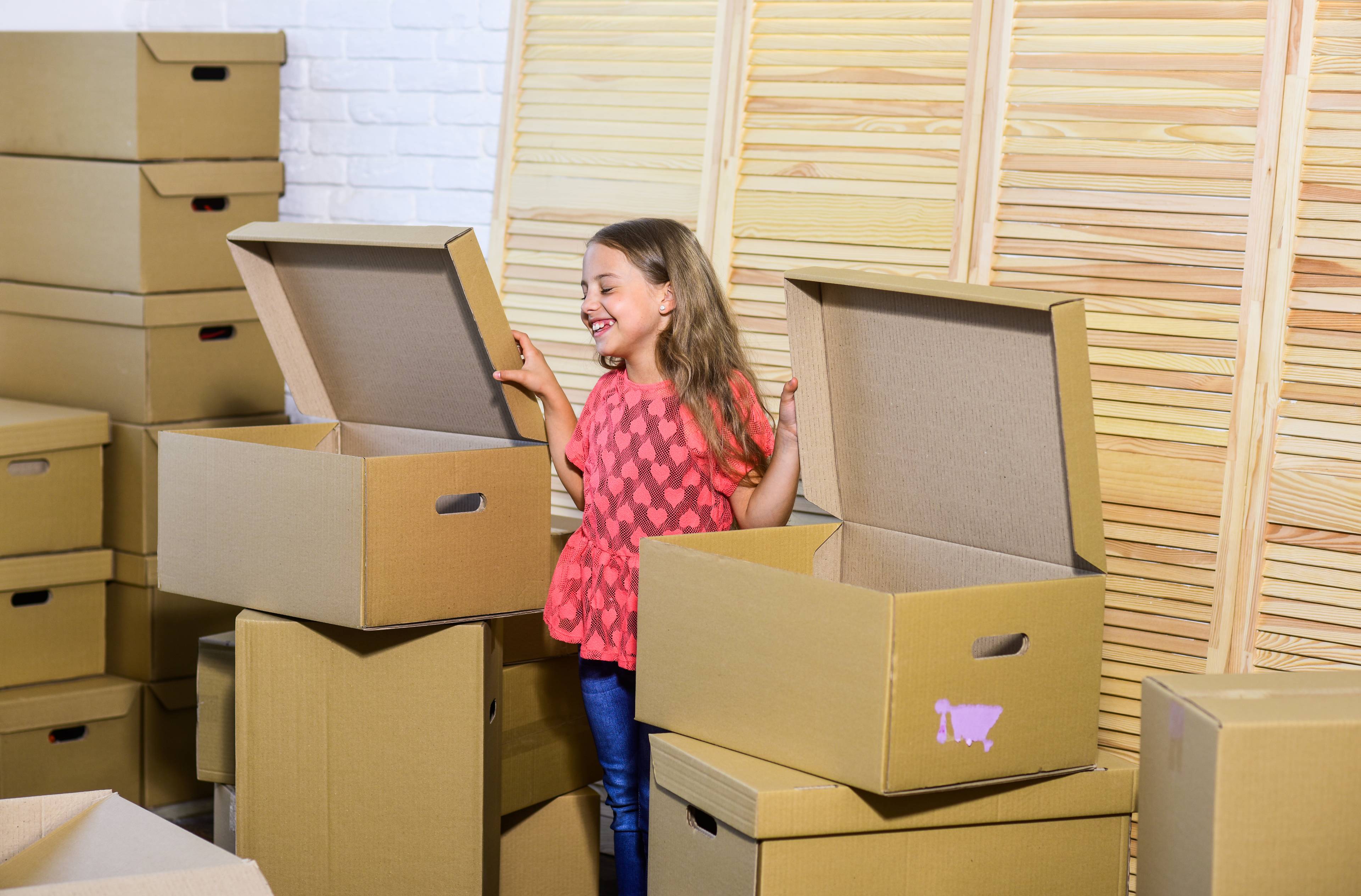 smiling girl with carboard boxes