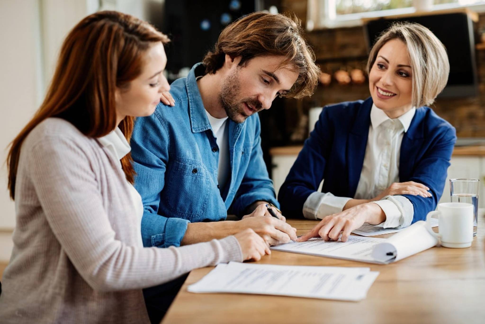 A man and a woman signing insurance papers