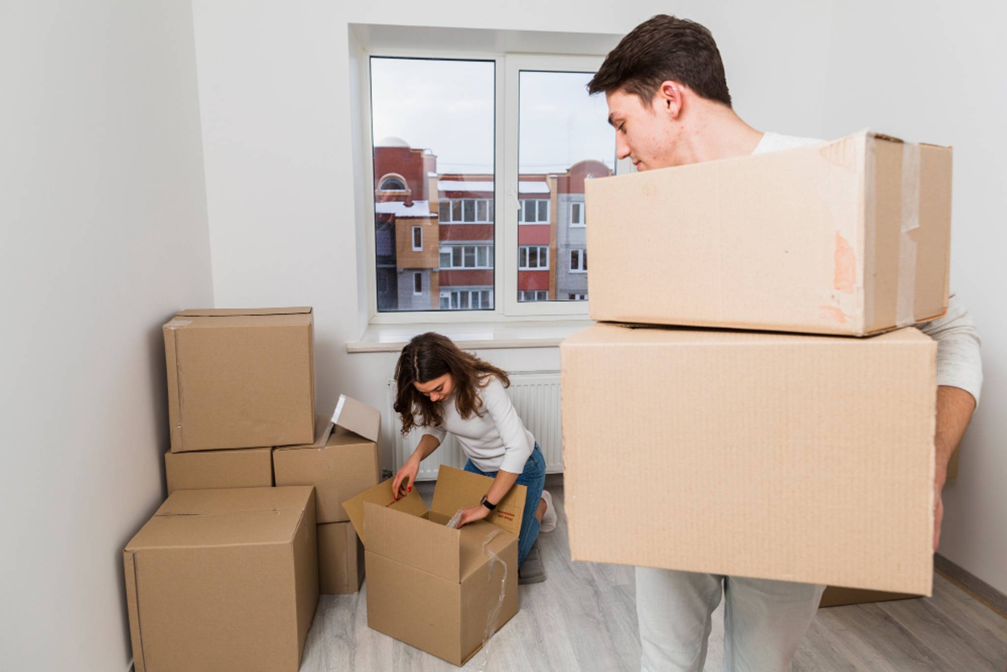 couple packing boxes to move to new London home