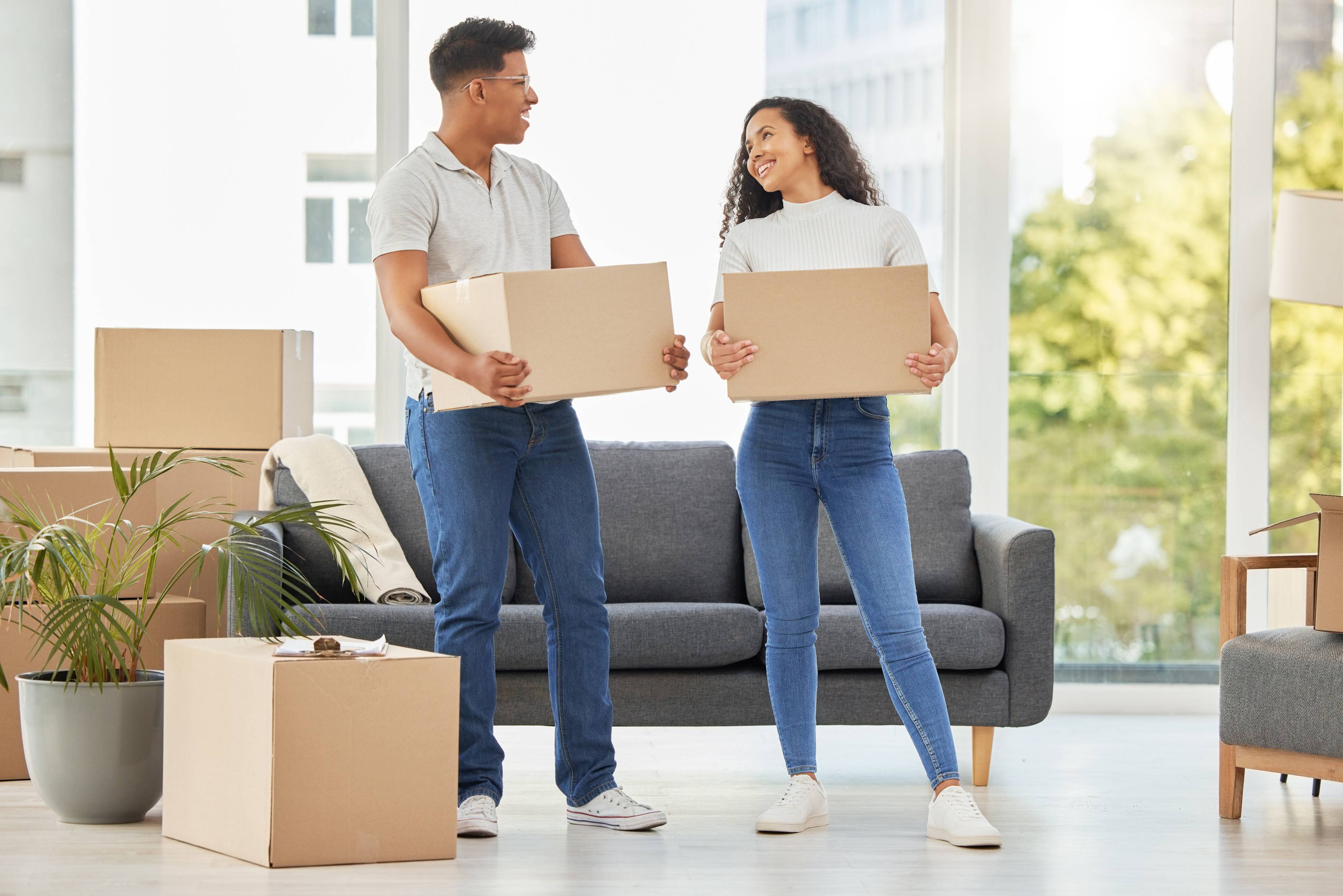 Couple together and moving with boxes in house teamwork for change in rent with real estate Man woman and packing for collaboration in property with mortgage investment in home for future growth