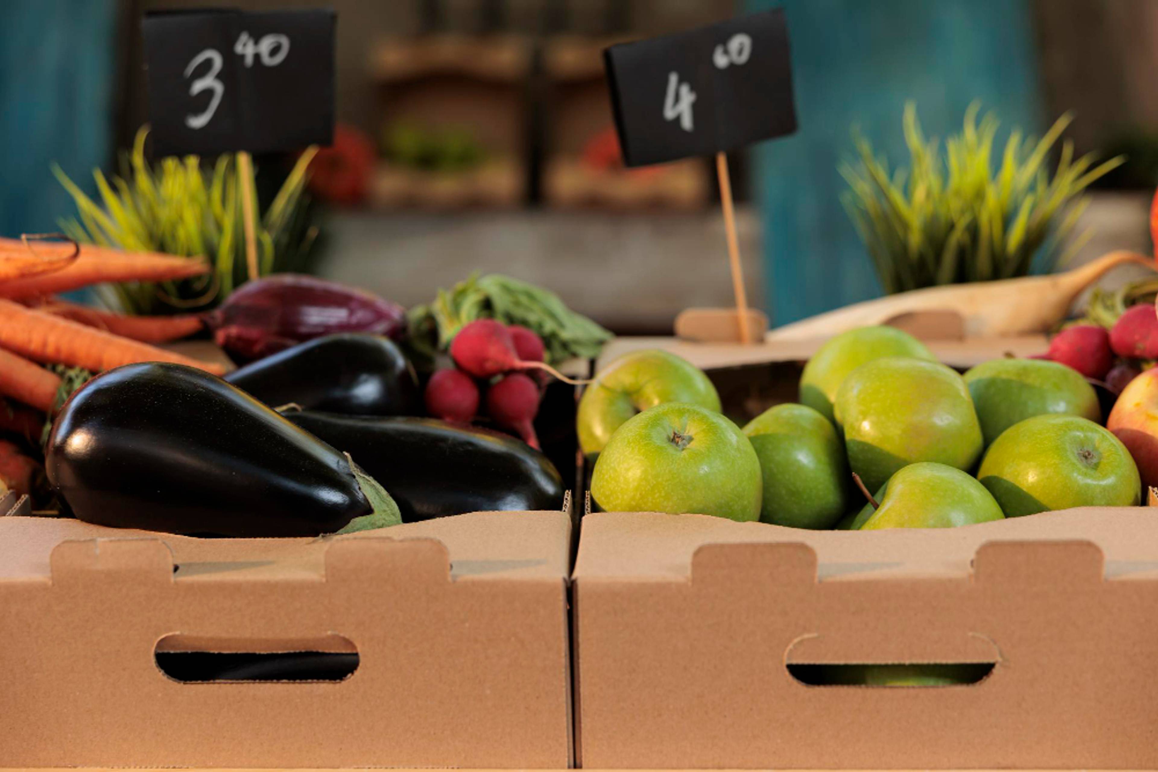 grocery store boxes with fruit and veg in