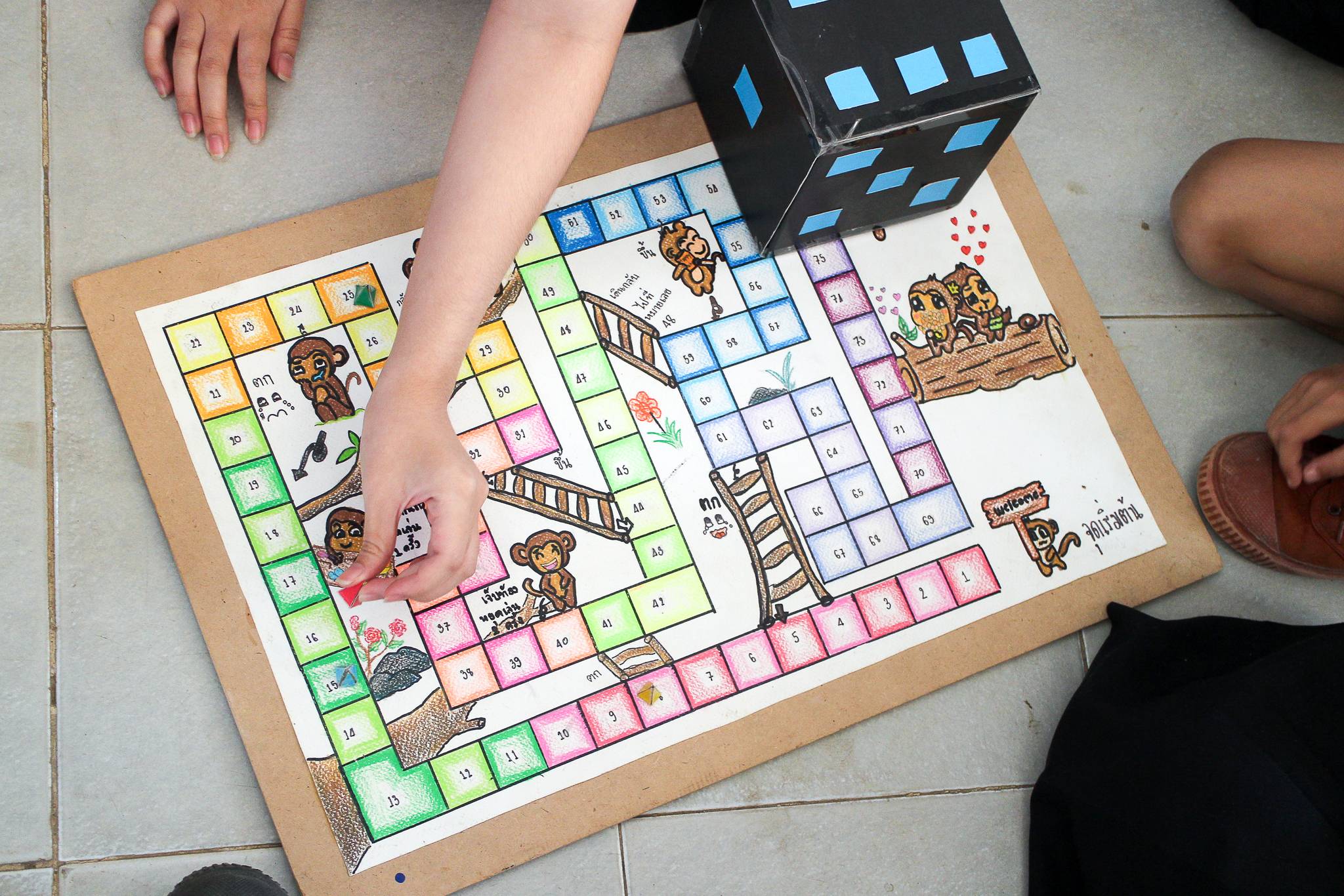 Children playing in DIY boardgame