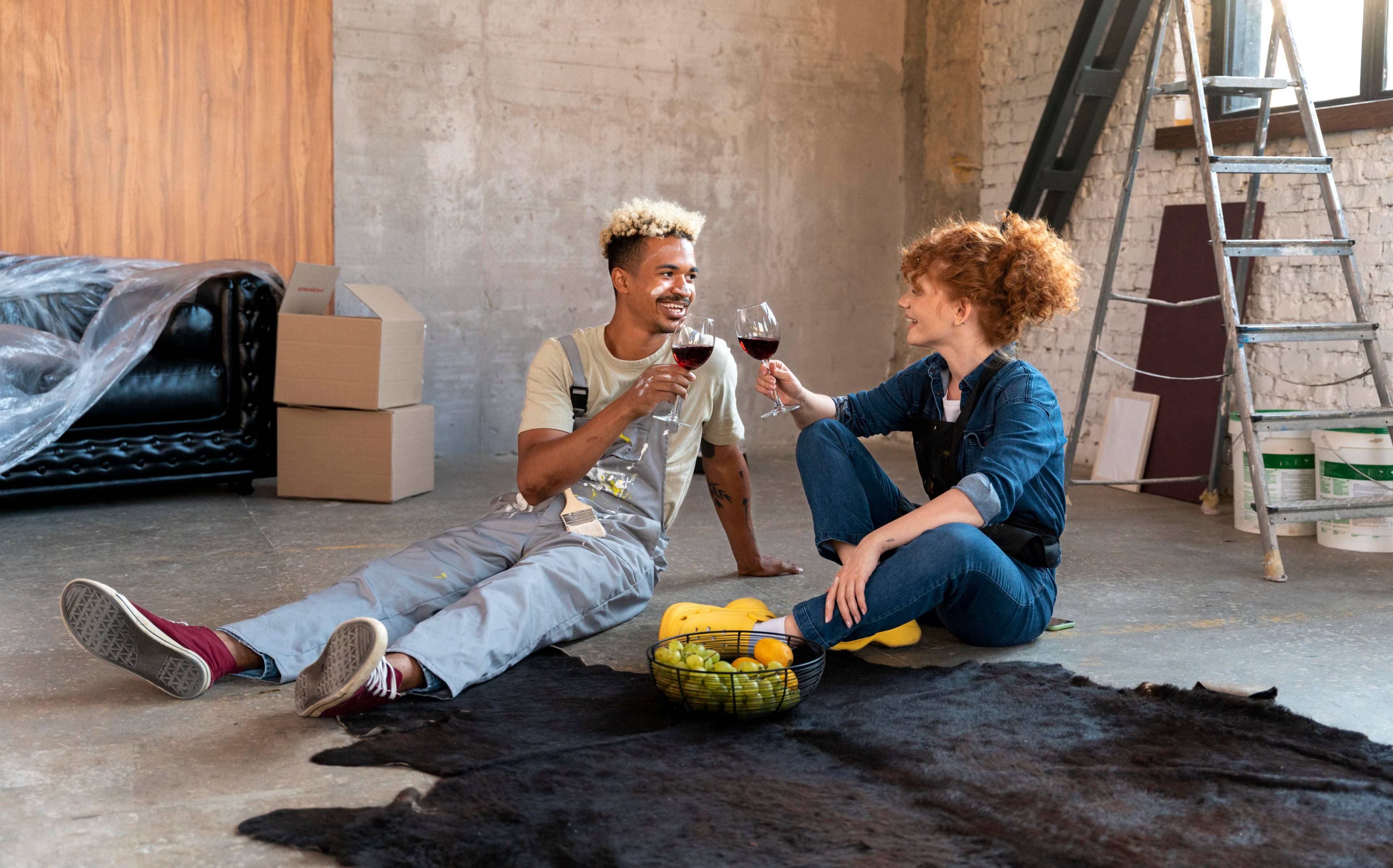 Couple sharing wine during working on house