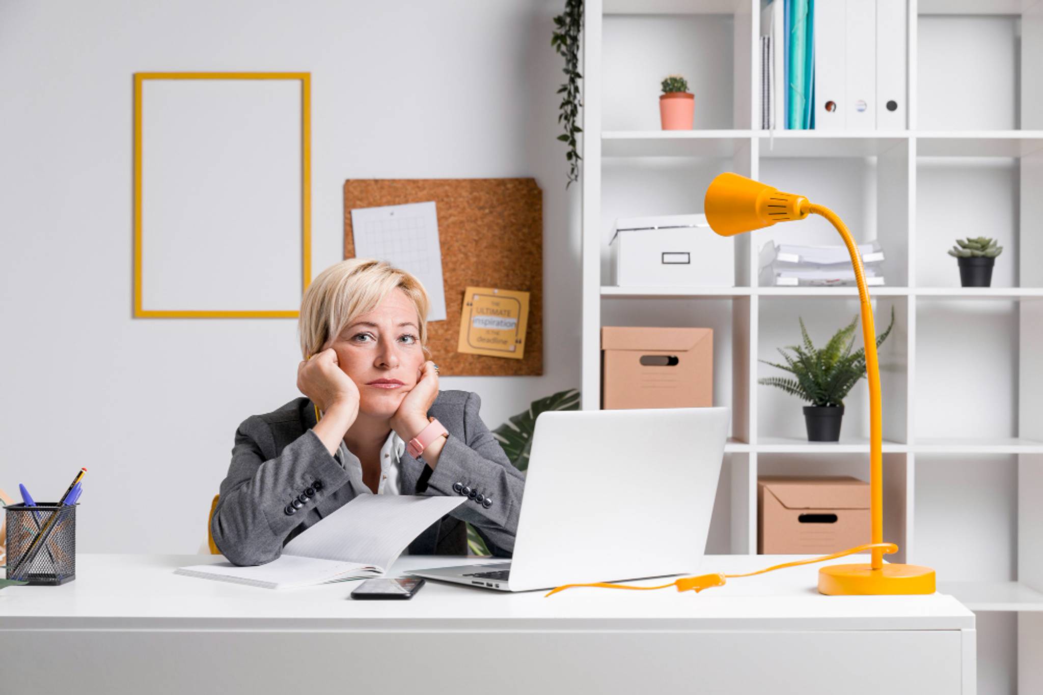Woman looking bored and annoyed, working in a well lit office