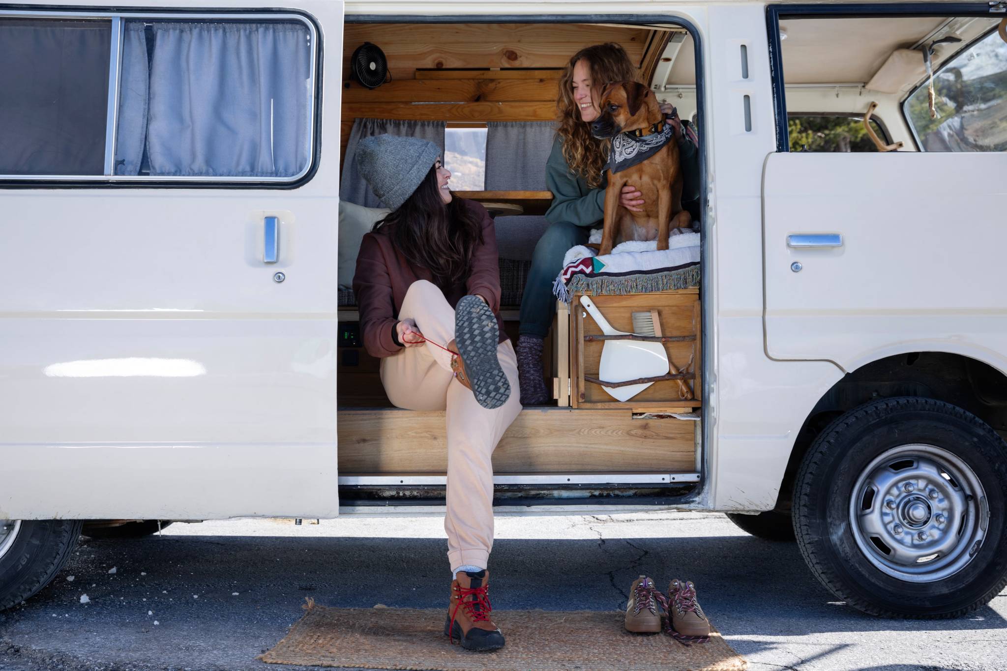 Woman putting her shoes on a van