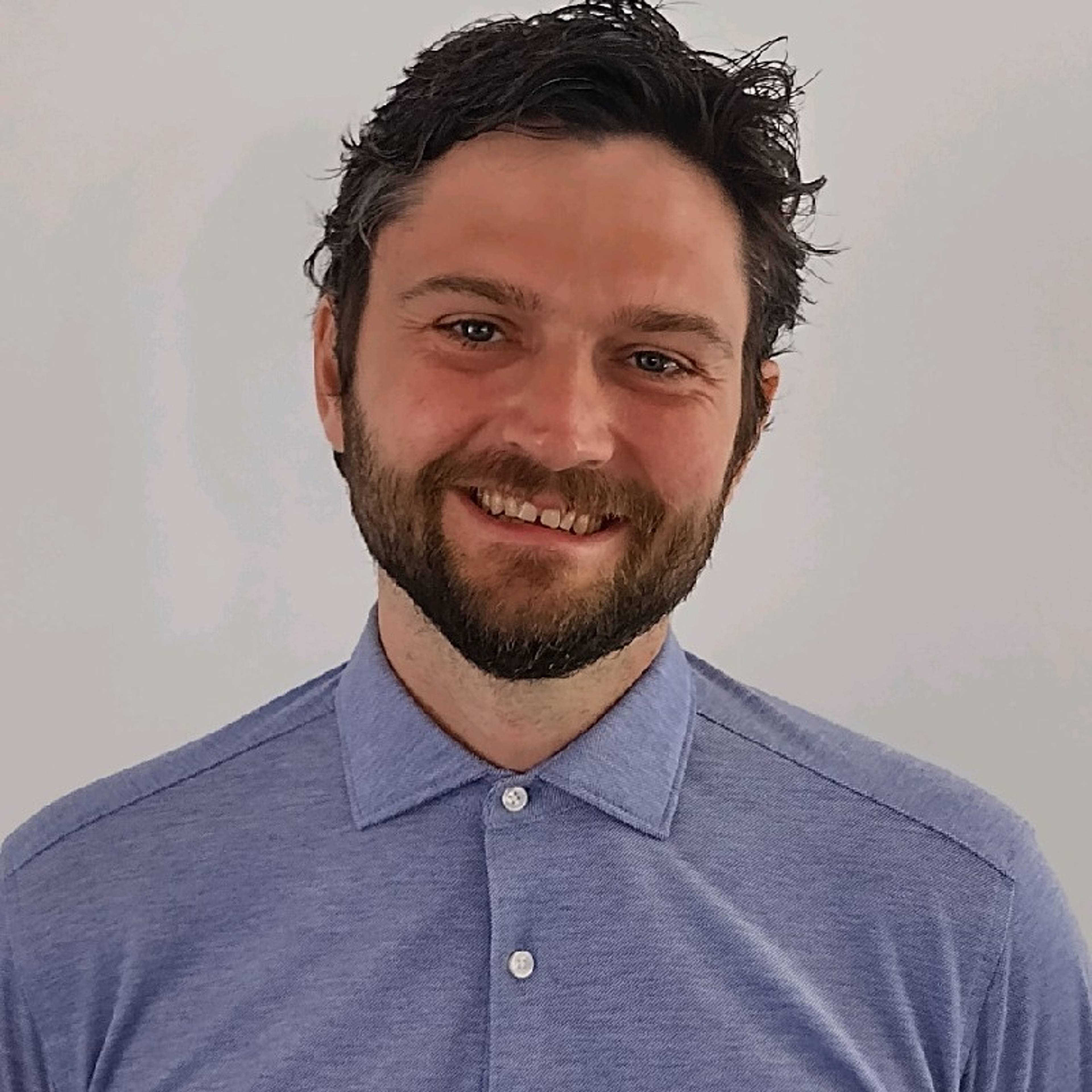 image of author smiling blue shirt